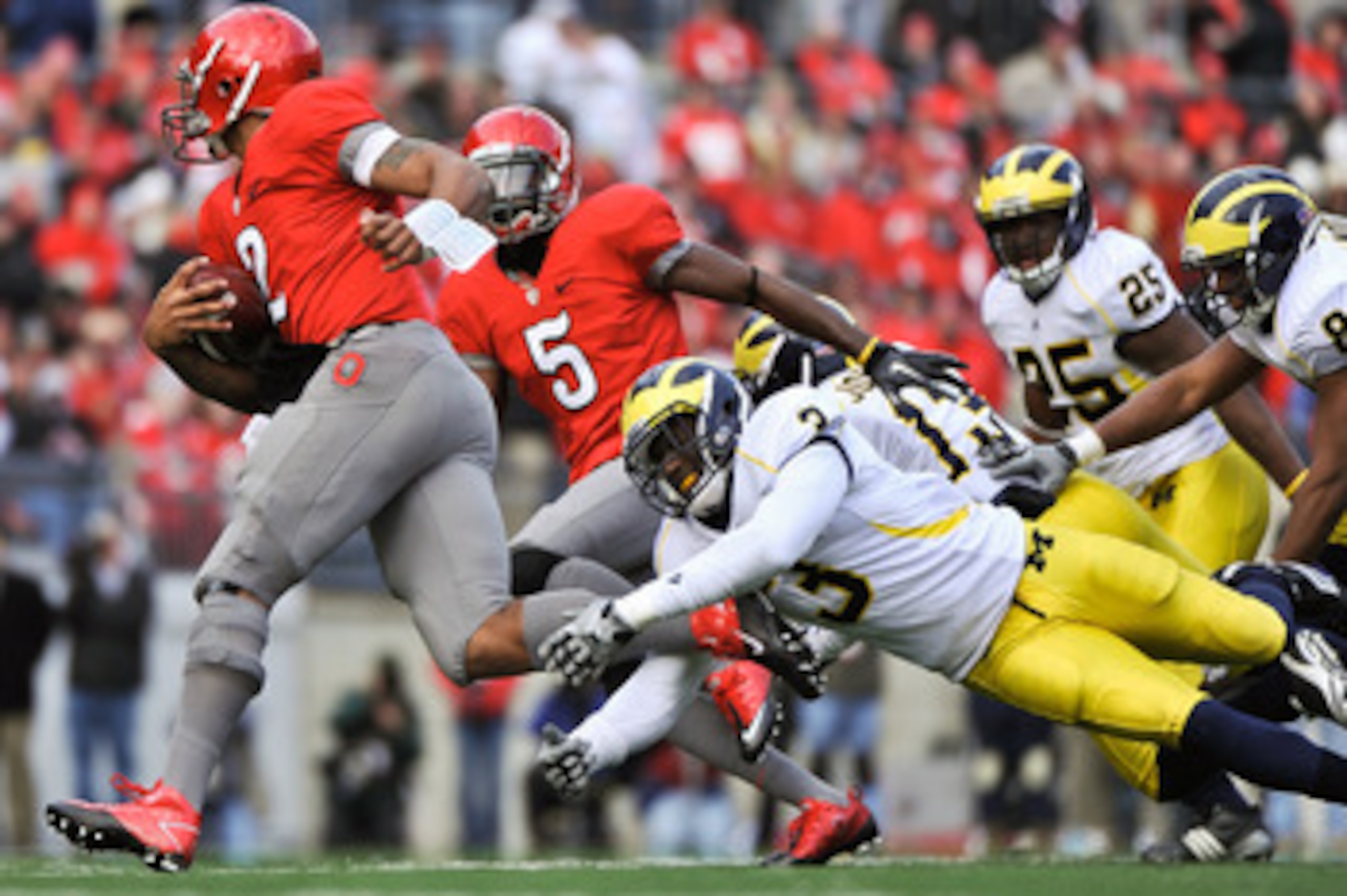 COLUMBUS, OH - NOVEMBER 27:  Marvin Robinson #3 of the Michigan Wolverines lunges to attempt a tackle on Terrelle Pryor #2 of the Ohio State Buckeyes at Ohio Stadium on November 27, 2010 in Columbus, Ohio.  (Photo by Jamie Sabau/Getty Images)
