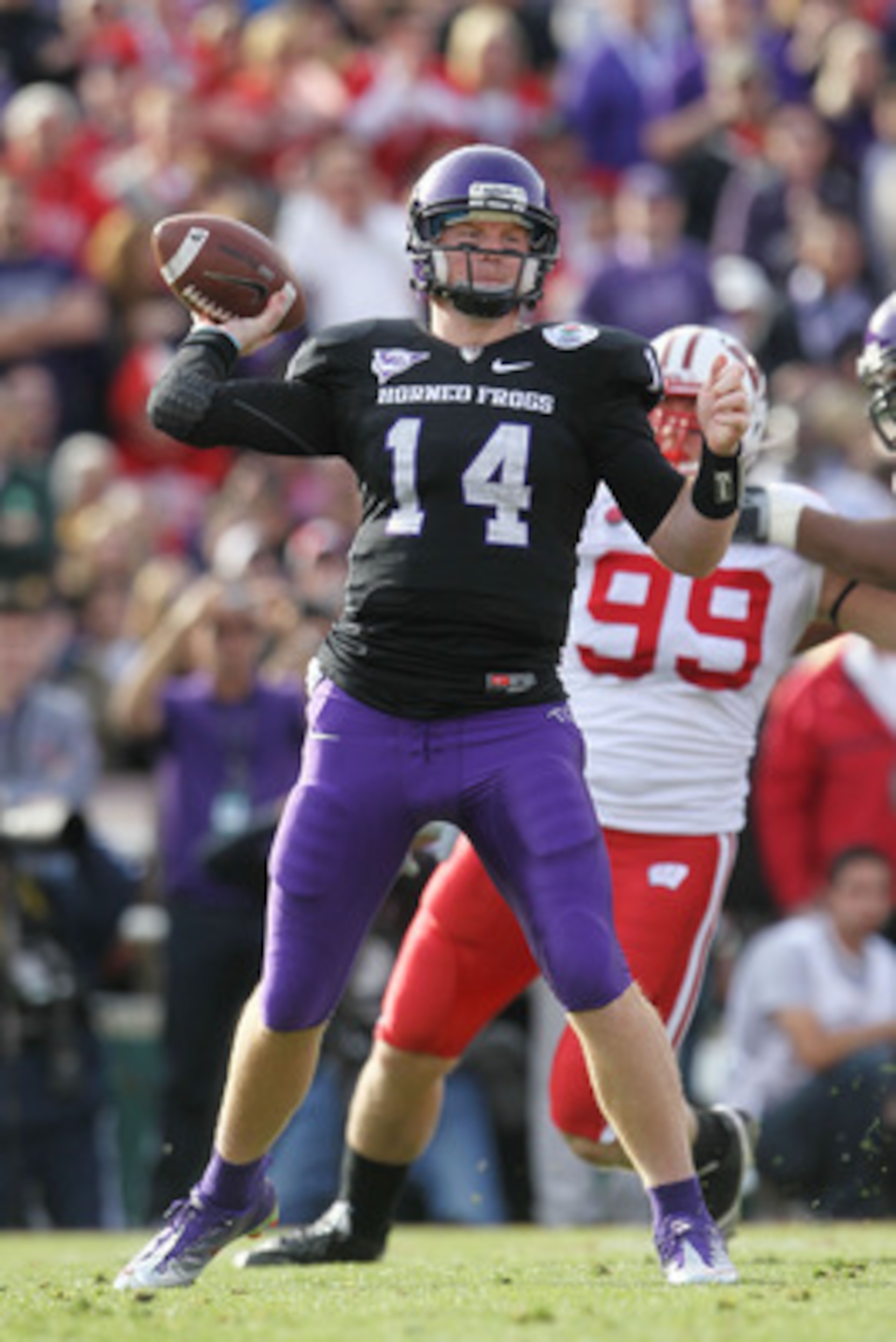 PASADENA, CA - JANUARY 01:  Quarterback Andy Dalton #14 of the TCU Horned Frogs throws a pass against the Wisconsin Badgers in the first quarter of the 97th Rose Bowl game on January 1, 2011 in Pasadena, California.  (Photo by Jeff Gross/Getty Images)