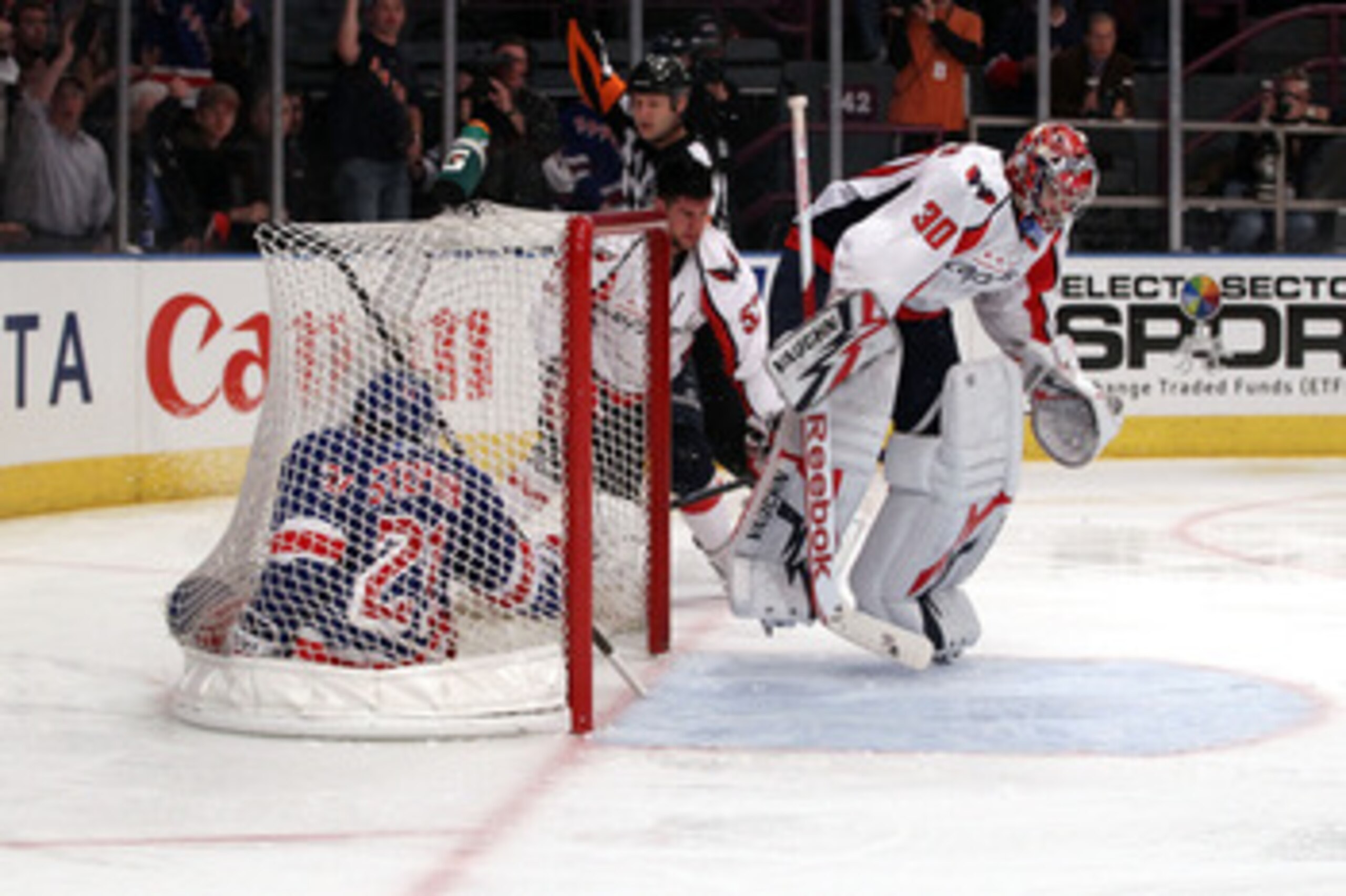 NEW YORK, NY - APRIL 20: Goalie Michal Neuvirth #30 of the Washington Capitals jumps over Derek Stepan #21 of the New York Rangers as Stepan slides into the net in Game Four of the Eastern Conference Quarterfinals during the 2011 NHL Stanley Cup Playoffs NEW YORK, NY - APRIL 20: Goalie Michal Neuvirth #30 of the Washington Capitals jumps over Derek Stepan #21 of the New York Rangers as Stepan slides into the net in Game Four of the Eastern Conference Quarterfinals during the 2011 NHL Stanley Cup Playoffs