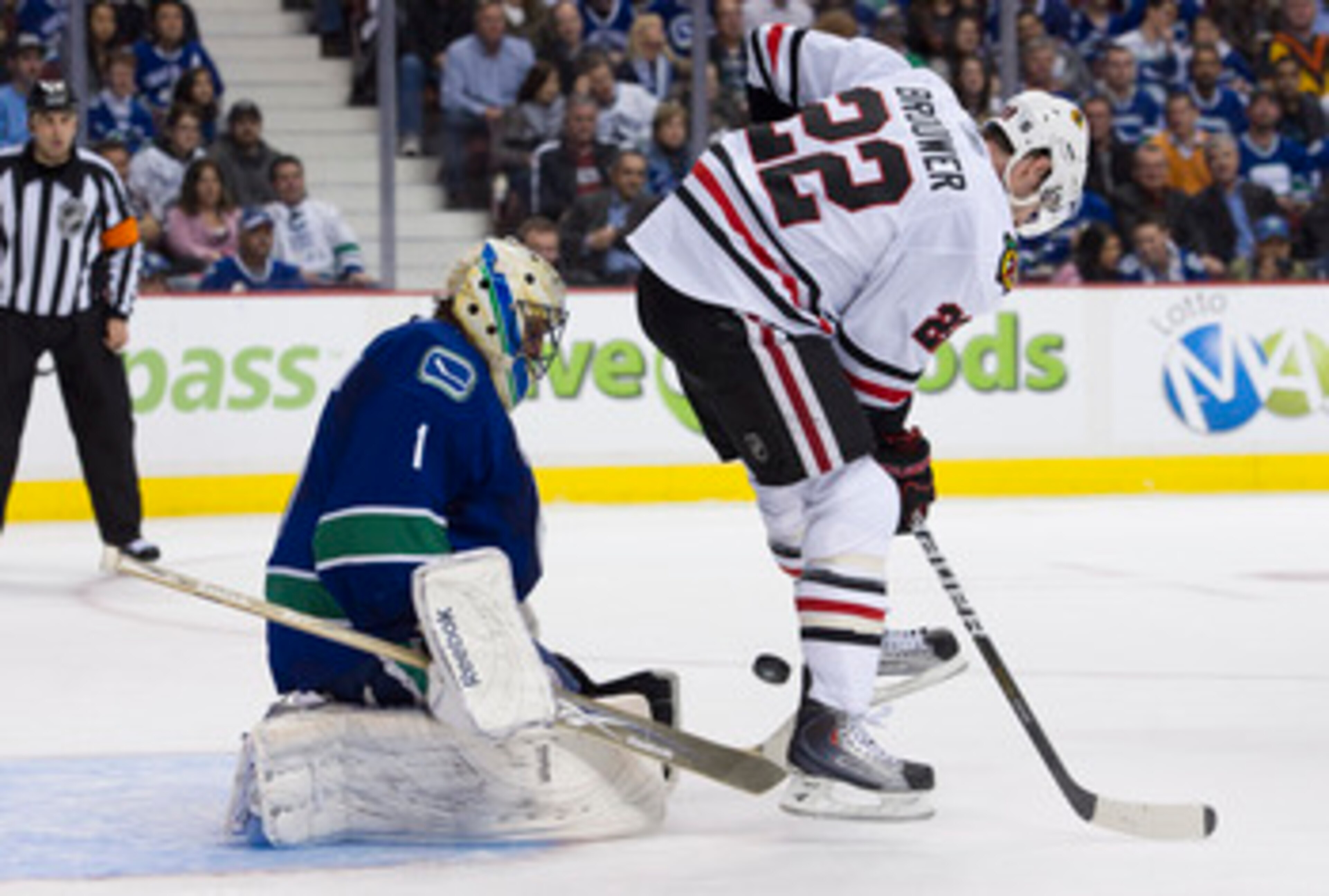 VANCOUVER, CANADA - APRIL 13: Troy Brouwer #22 of the Chicago Blackhawks tries to deflect the puck past goalie Roberto Luongo #1 of the Vancouver Canucks during the second period in Game One of the Western Conference Quarterfinals during the 2011 NHL Stan