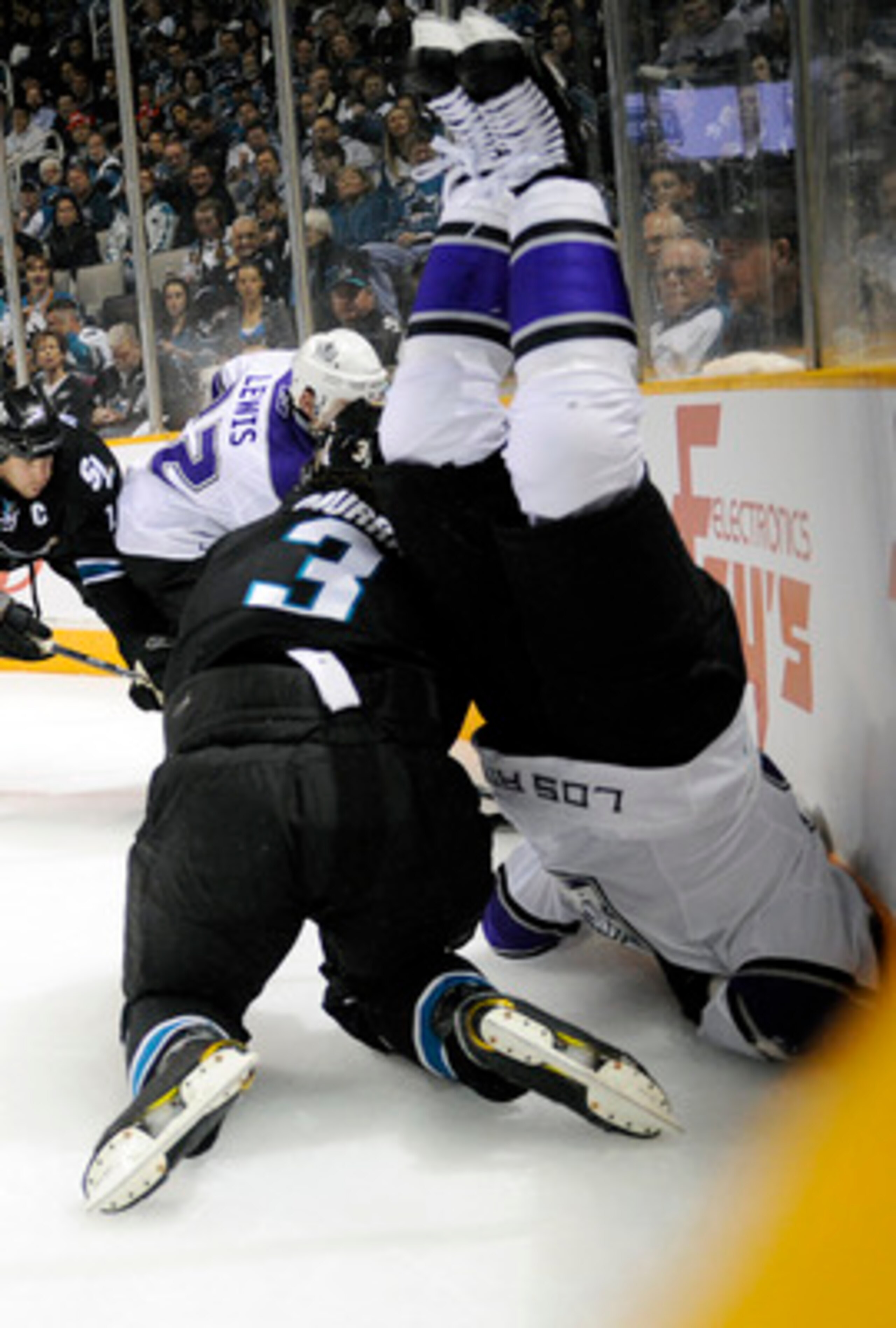 SAN JOSE, CA - APRIL 14: Dustin Brown #23 of the Los Angeles Kings flips over Douglas Murray #3 of the San Jose Sharks in Game One of the Western Conference Quarterfinals during the 2011 NHL Stanley Cup Playoffs at the HP Pavilion on April 14, 2011 in Sa SAN JOSE, CA - APRIL 14: Dustin Brown #23 of the Los Angeles Kings flips over Douglas Murray #3 of the San Jose Sharks in Game One of the Western Conference Quarterfinals during the 2011 NHL Stanley Cup Playoffs at the HP Pavilion on April 14, 2011 in Sa