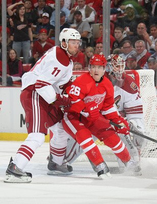 DETROIT, MI- APRIL 13:  Jiri Hudler #26 of the Detroit Red Wings battles for position with Martin Hanzal #11 of the Phoenix Coyotes in Game One of the Western Conference Quarterfinals during the 2011 NHL Stanley Cup Playoffs at Joe Louis Arena on April 13