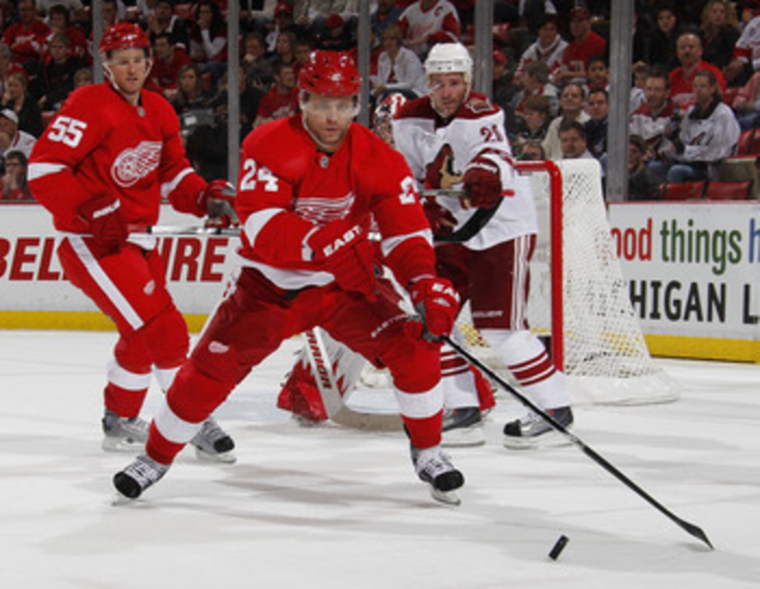 DETROIT, MI - APRIL 16: Ruslan Salei #24 of the Detroit Red Wings tries to control the puck in front of Eric Belanger #20 of the Phoenix Coyotes in Game Two of the Western Conference Quarterfinals during the 2011 Stanley Cup Playoffs at Joe Louis Arena o DETROIT, MI - APRIL 16: Ruslan Salei #24 of the Detroit Red Wings tries to control the puck in front of Eric Belanger #20 of the Phoenix Coyotes in Game Two of the Western Conference Quarterfinals during the 2011 Stanley Cup Playoffs at Joe Louis Arena o