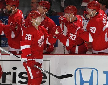 DETROIT, MI - APRIL 16:  Brian Rafalski #28 of the Detroit Red Wings celebrates a first-period goal with the bench while playing the Phoenix Coyotes in Game Two of the Western Conference Quarterfinals during the 2011 Stanley Cup Playoffs at Joe Louis Aren