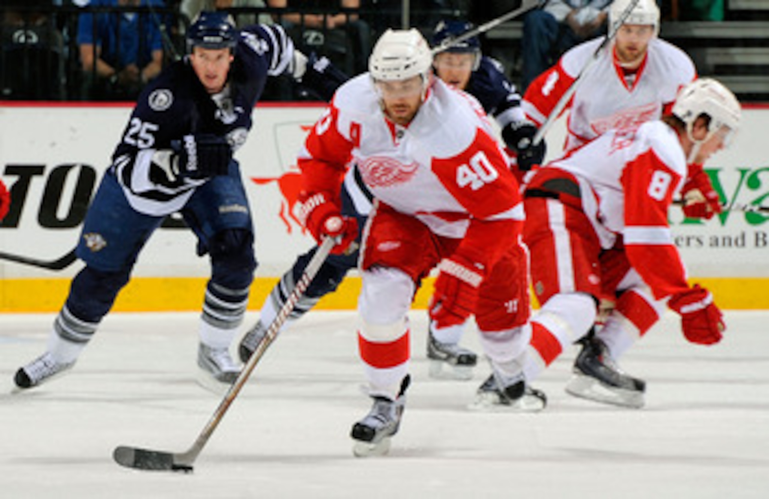 NASHVILLE, TN - APRIL 02: Henrik Zetterberg #40 of the Detroit Red Wings carries the puck ahead of Jerred Smithson #25 of the Nashville Predators on April 2, 2011 at the Bridgestone Arena in Nashville, Tennessee. (Photo by Frederick Breedon/Getty Images NASHVILLE, TN - APRIL 02: Henrik Zetterberg #40 of the Detroit Red Wings carries the puck ahead of Jerred Smithson #25 of the Nashville Predators on April 2, 2011 at the Bridgestone Arena in Nashville, Tennessee. (Photo by Frederick Breedon/Getty Images