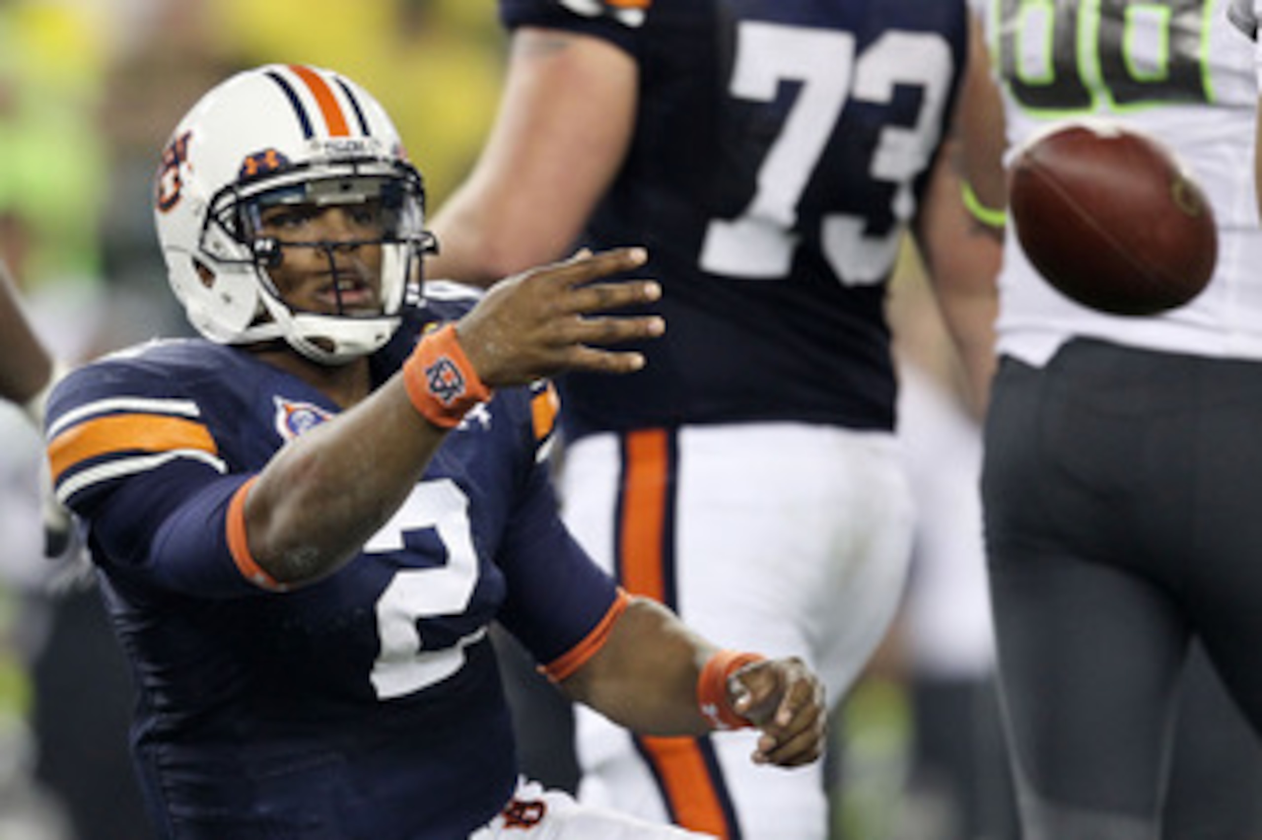 GLENDALE, AZ - JANUARY 10:  Cameron Newton #2 of the Auburn Tigers tosses the ball after being sacked by the Oregon Ducks during the Tostitos BCS National Championship Game at University of Phoenix Stadium on January 10, 2011 in Glendale, Arizona.  (Photo