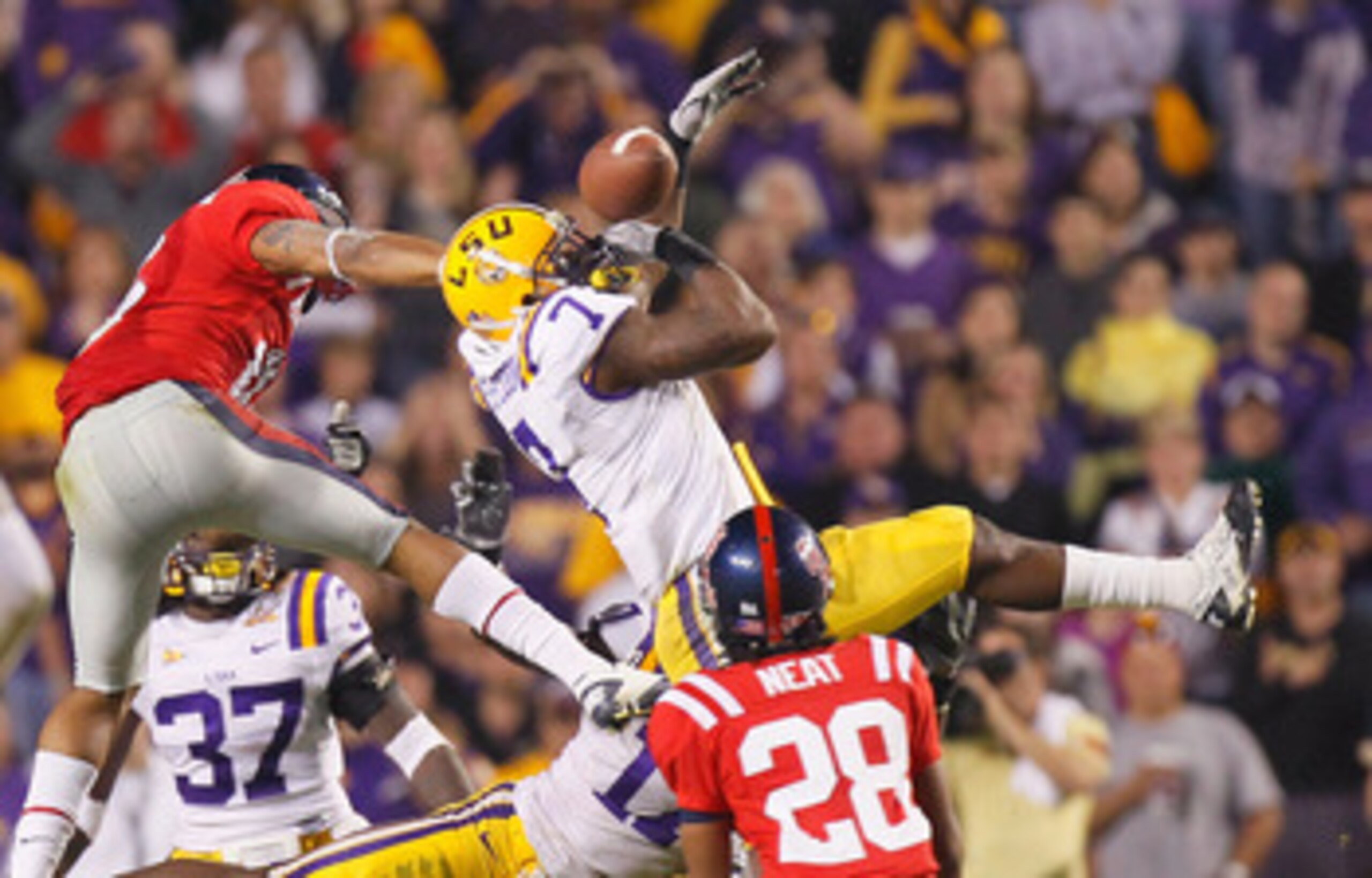 BATON ROUGE, LA - NOVEMBER 20:  Patrick Peterson #7 of the Louisiana State University Tigers nearly intercepts a pass in the final seconds against Markeith Summers #16 and Korvic Neat #28 of the Ole Miss Rebels as time expired at Tiger Stadium on November