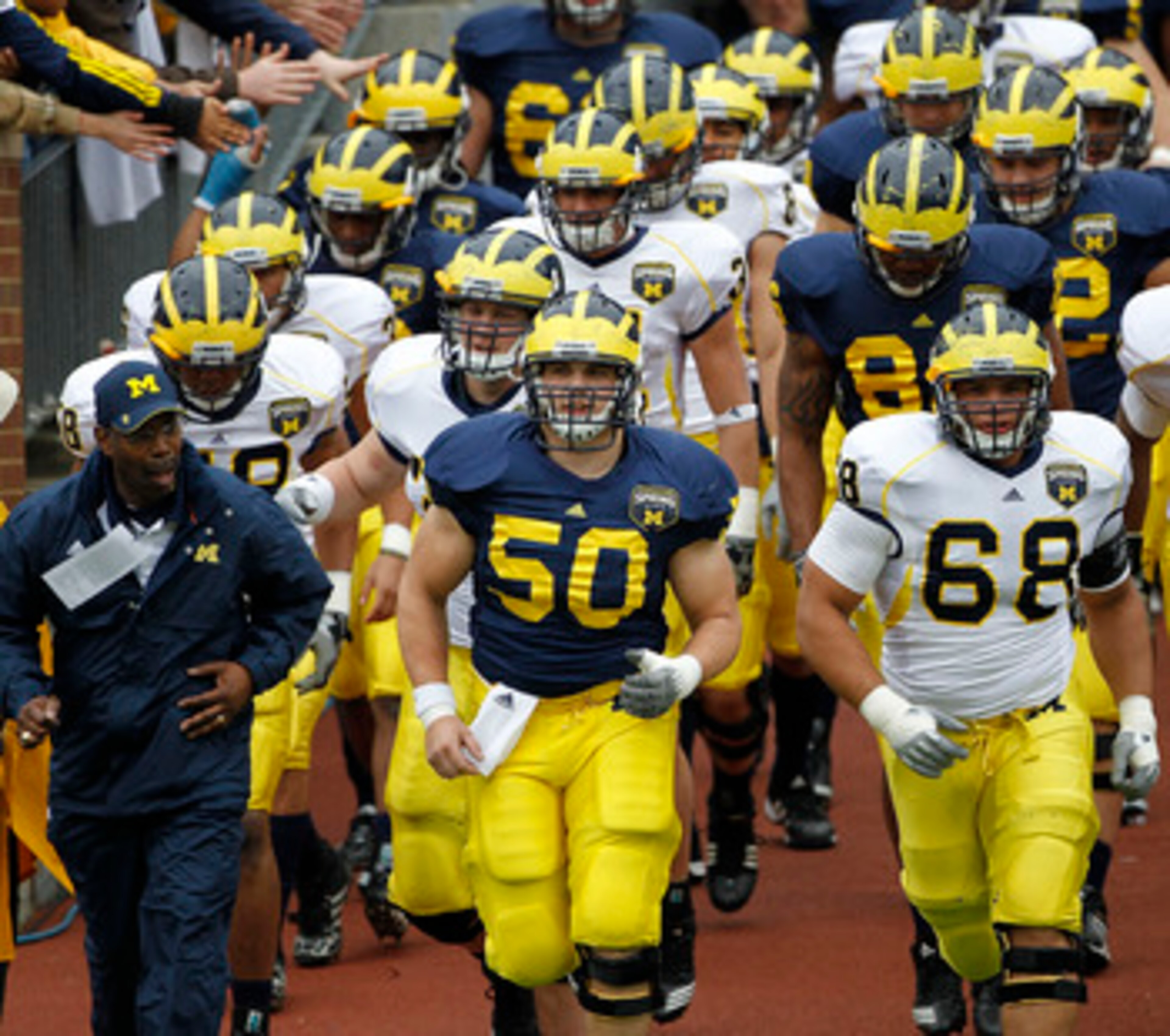 ANN ARBOR, MI - APRIL 16: David Molk #50 and Mike Martin #68 of the Michigan Wolverines lead their team onto the field prior to the start of the annual Spring Game at Michigan Stadium on April 16, 2011 in Ann Arbor, Michigan. (Photo by Leon Halip/Getty ANN ARBOR, MI - APRIL 16: David Molk #50 and Mike Martin #68 of the Michigan Wolverines lead their team onto the field prior to the start of the annual Spring Game at Michigan Stadium on April 16, 2011 in Ann Arbor, Michigan. (Photo by Leon Halip/Getty
