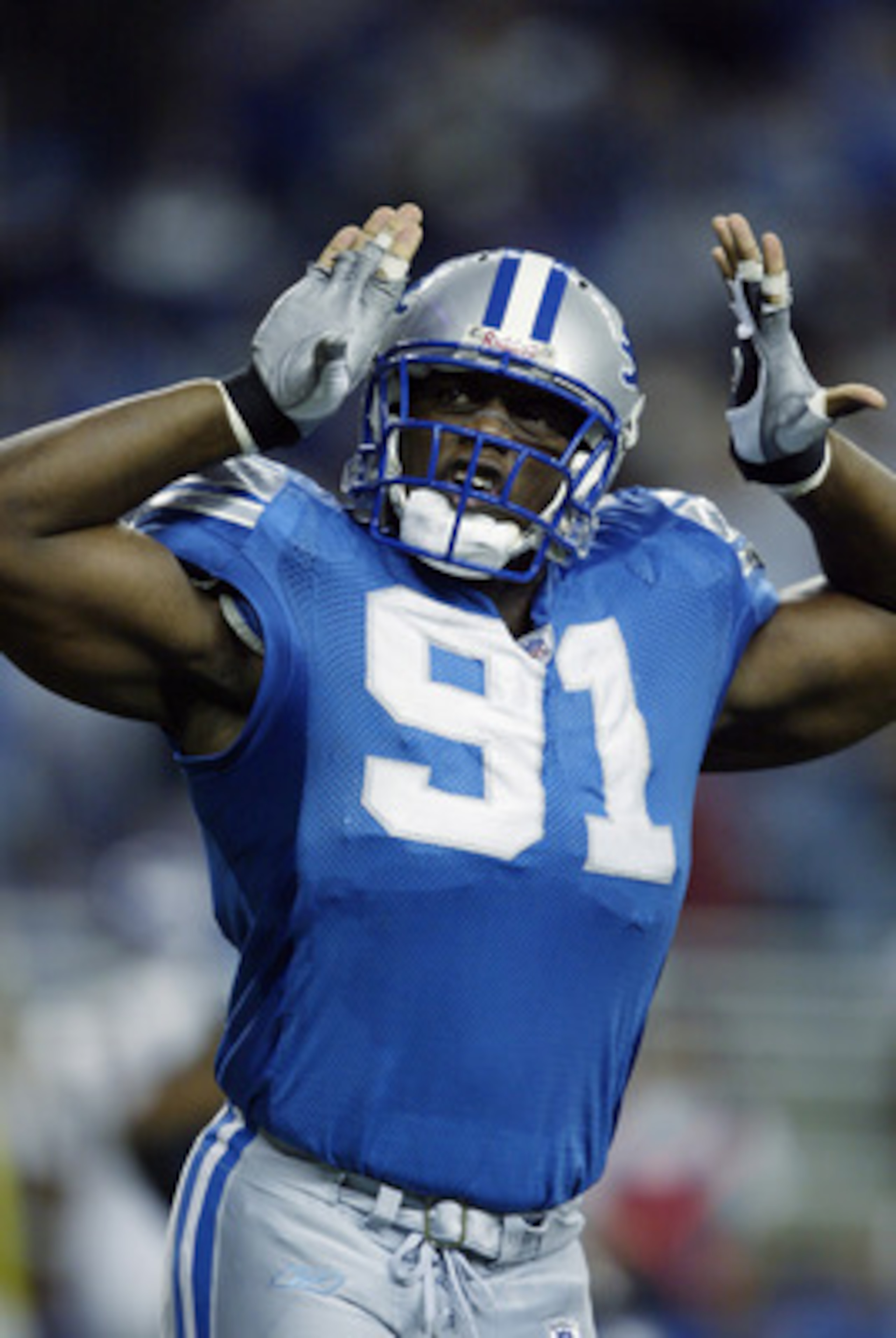 DETROIT- DECEMBER 29:  Defensive end Robert Porcher #91 of the Detroit Lions celebrates during the NFL game against the Minnesota Vikings at Ford Field on December 29, 2002 in Detroit, Michigan.  The Vikings defeated the Lions 38-36.  (Photo by Tom Pidgeo