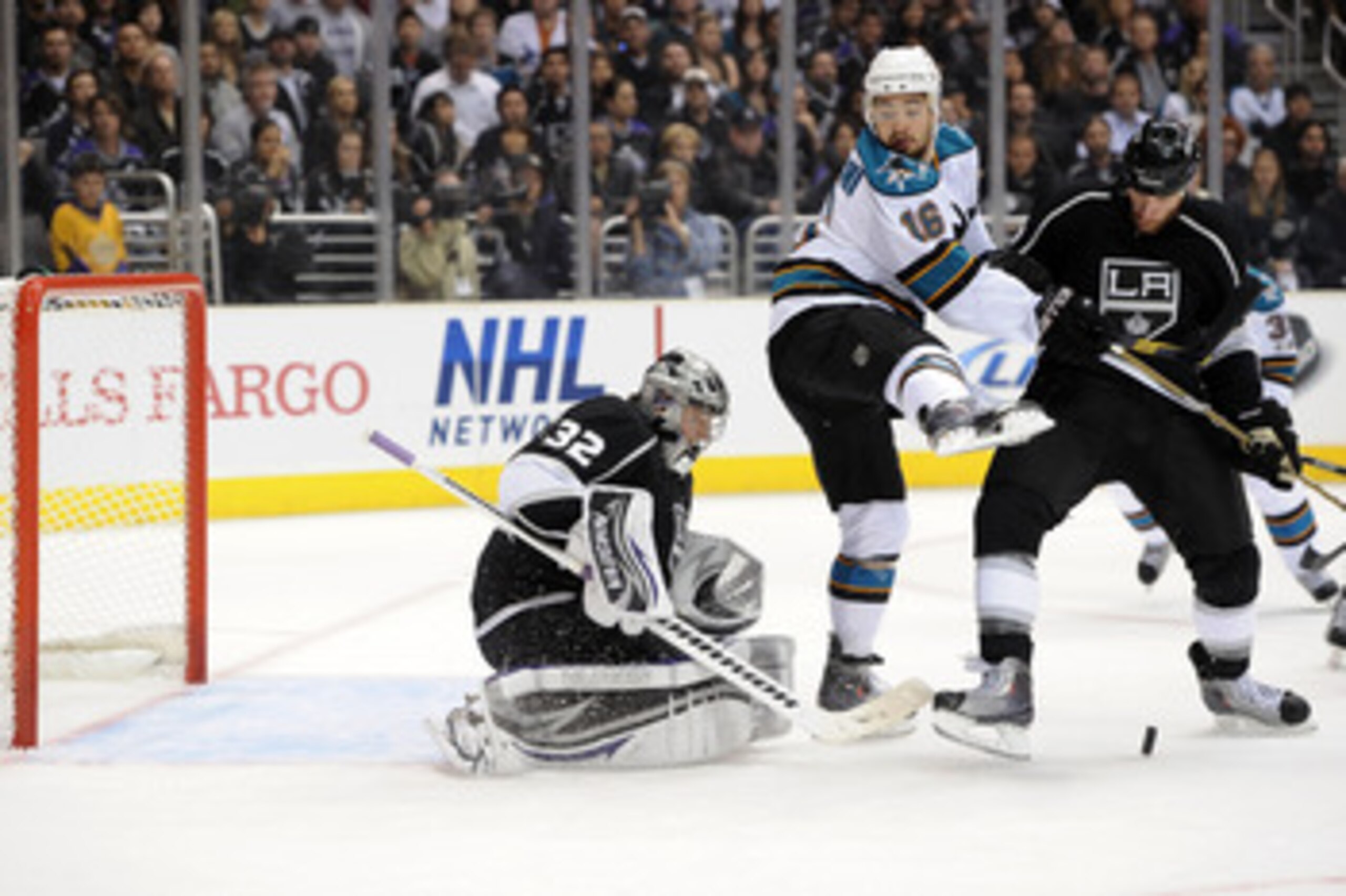 LOS ANGELES, CA - APRIL 21:  Devin Setoguchi #16 of the San Jose Sharks shieds a shot on Jonathan Quick #32 of the Los Angeles Kings in the first period of game four of the Western Conference Quarterfinals during the 2011 NHL Stanley Cup Playoffs at Stapl