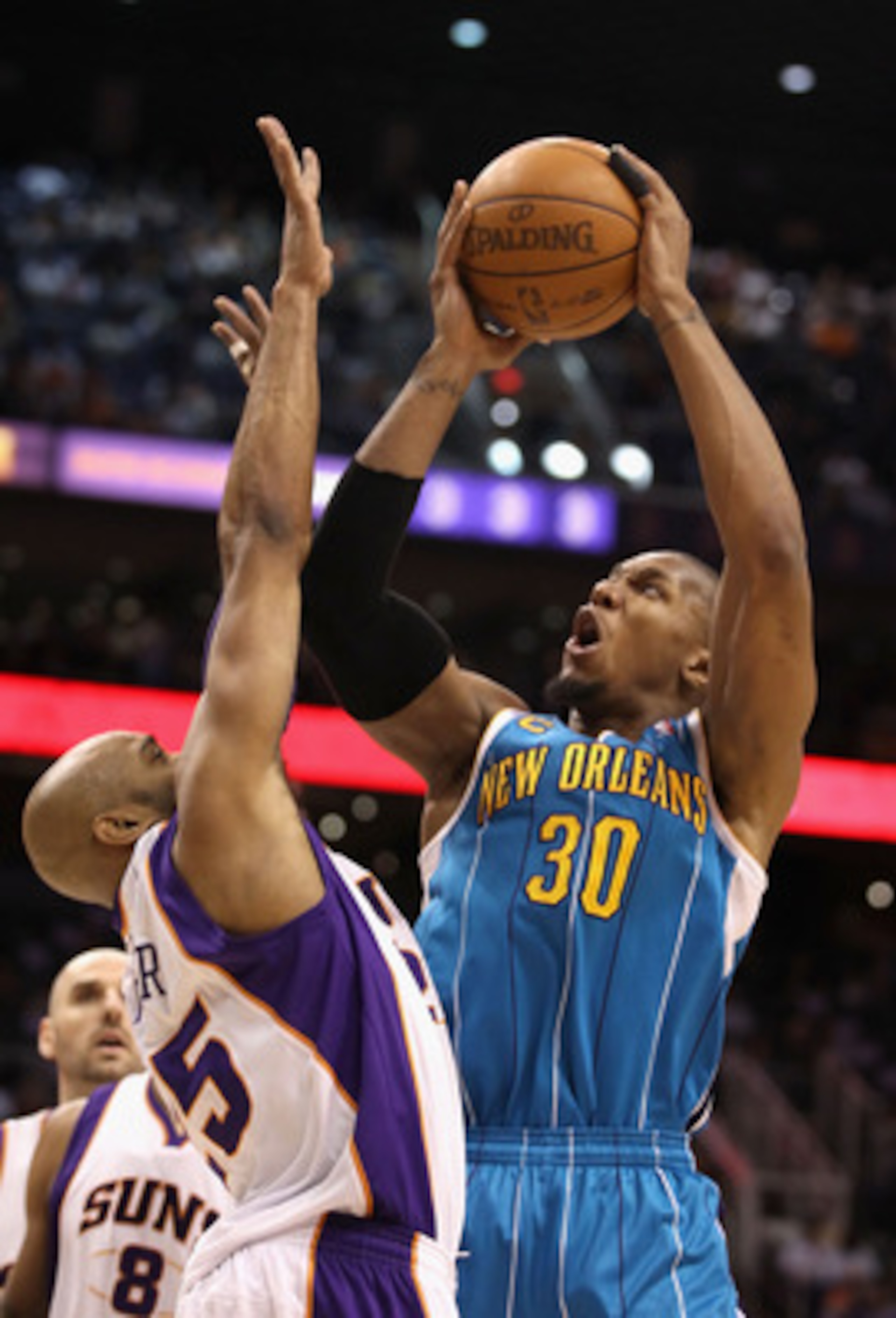 PHOENIX, AZ - JANUARY 30: David West #30 of the New Orleans Hornets puts up a shot over Vince Carter #25 of the Phoenix Suns during the NBA game at US Airways Center on January 30, 2011 in Phoenix, Arizona. NOTE TO USER: User expressly acknowledges and PHOENIX, AZ - JANUARY 30: David West #30 of the New Orleans Hornets puts up a shot over Vince Carter #25 of the Phoenix Suns during the NBA game at US Airways Center on January 30, 2011 in Phoenix, Arizona. NOTE TO USER: User expressly acknowledges and