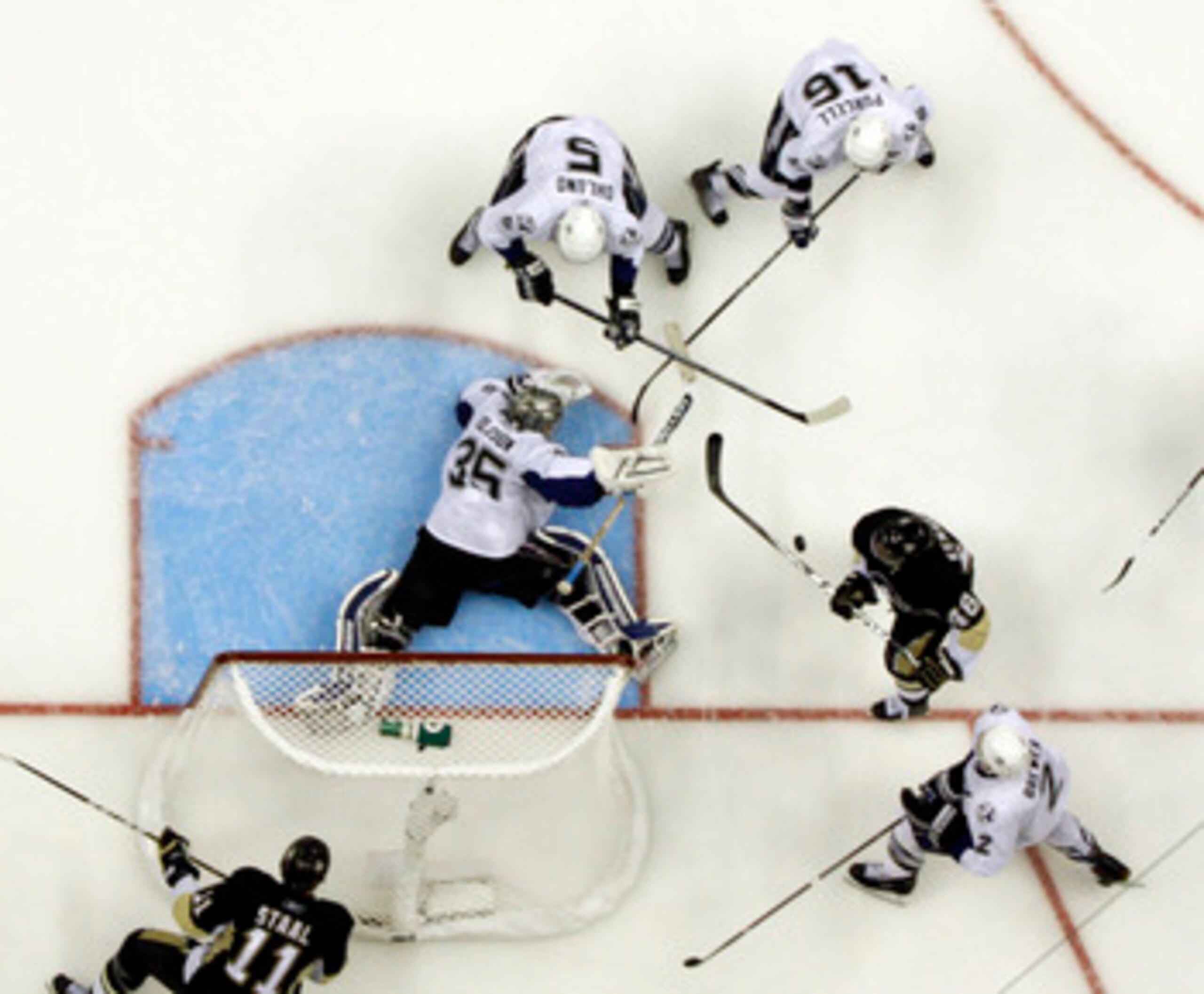 PITTSBURGH, PA - APRIL 27:  Dwayne Roloson #35 of the Tampa Bay Lightning makes a save on Tyler Kennedy #48 of the Pittsburgh Penguins in Game Seven of the Eastern Conference Quarterfinals during the 2011 NHL Stanley Cup Playoffs at Consol Energy Center o