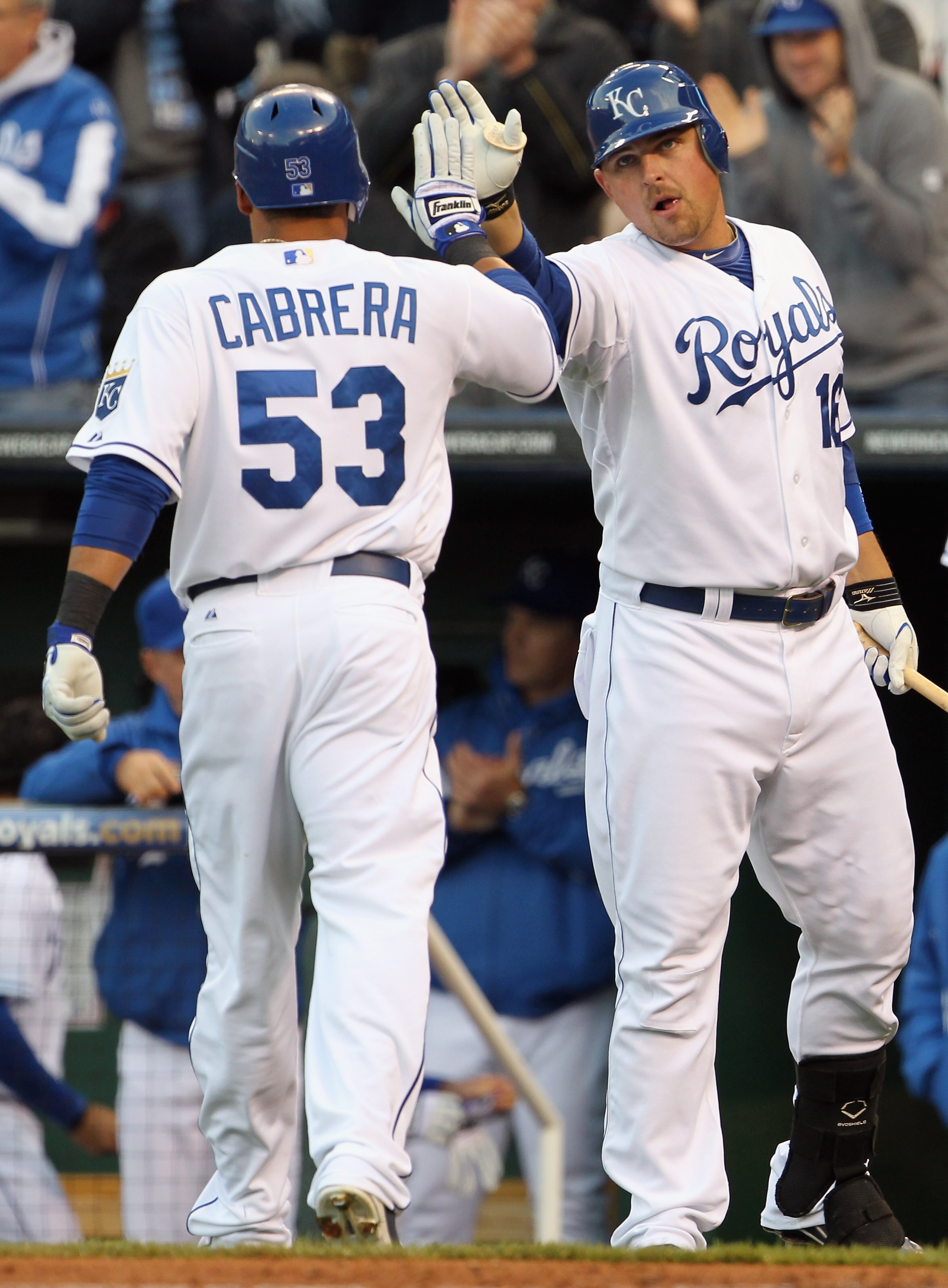 KANSAS CITY, MO - APRIL 20:  Billy Butler #16 of the Kansas City Royals congratulates Melky Cabrera #53 after Cabrera scored on an Alex Gordon triple during the 1st inning of the game against the Cleveland Indians on April 20, 2011 at Kauffman Stadium in