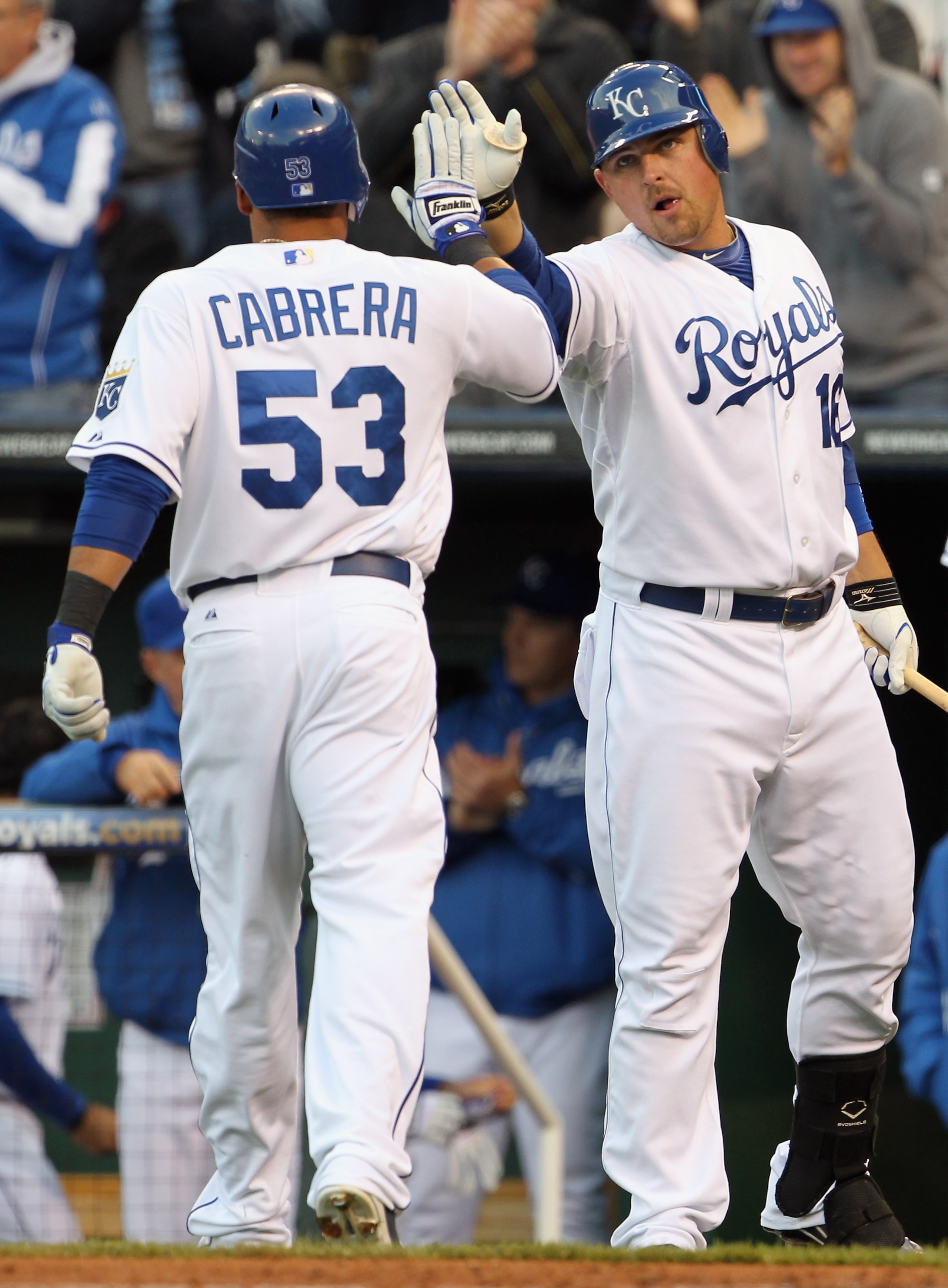KANSAS CITY, MO - APRIL 20:  Billy Butler #16 of the Kansas City Royals congratulates Melky Cabrera #53 after Cabrera scored on an Alex Gordon triple during the 1st inning of the game against the Cleveland Indians on April 20, 2011 at Kauffman Stadium in