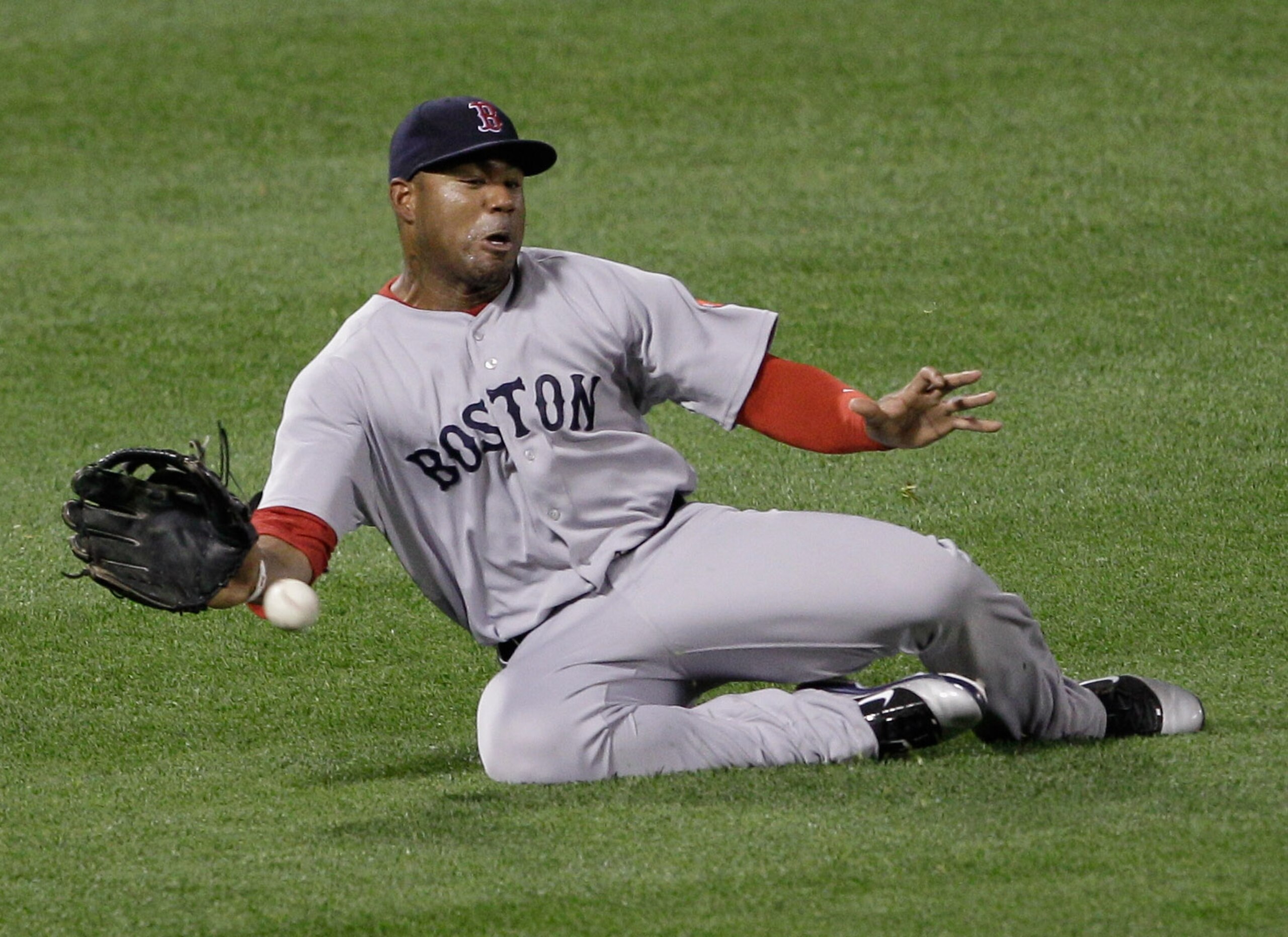 BALTIMORE, MD - APRIL 26:  Left fielder Carl Crawford #13 of the Boston Red Sox one hops a single by Vladimir Guerrero #27 of the Baltimore Orioles during the fifth inning at Oriole Park at Camden Yards on April 26, 2011 in Baltimore, Maryland.  (Photo by