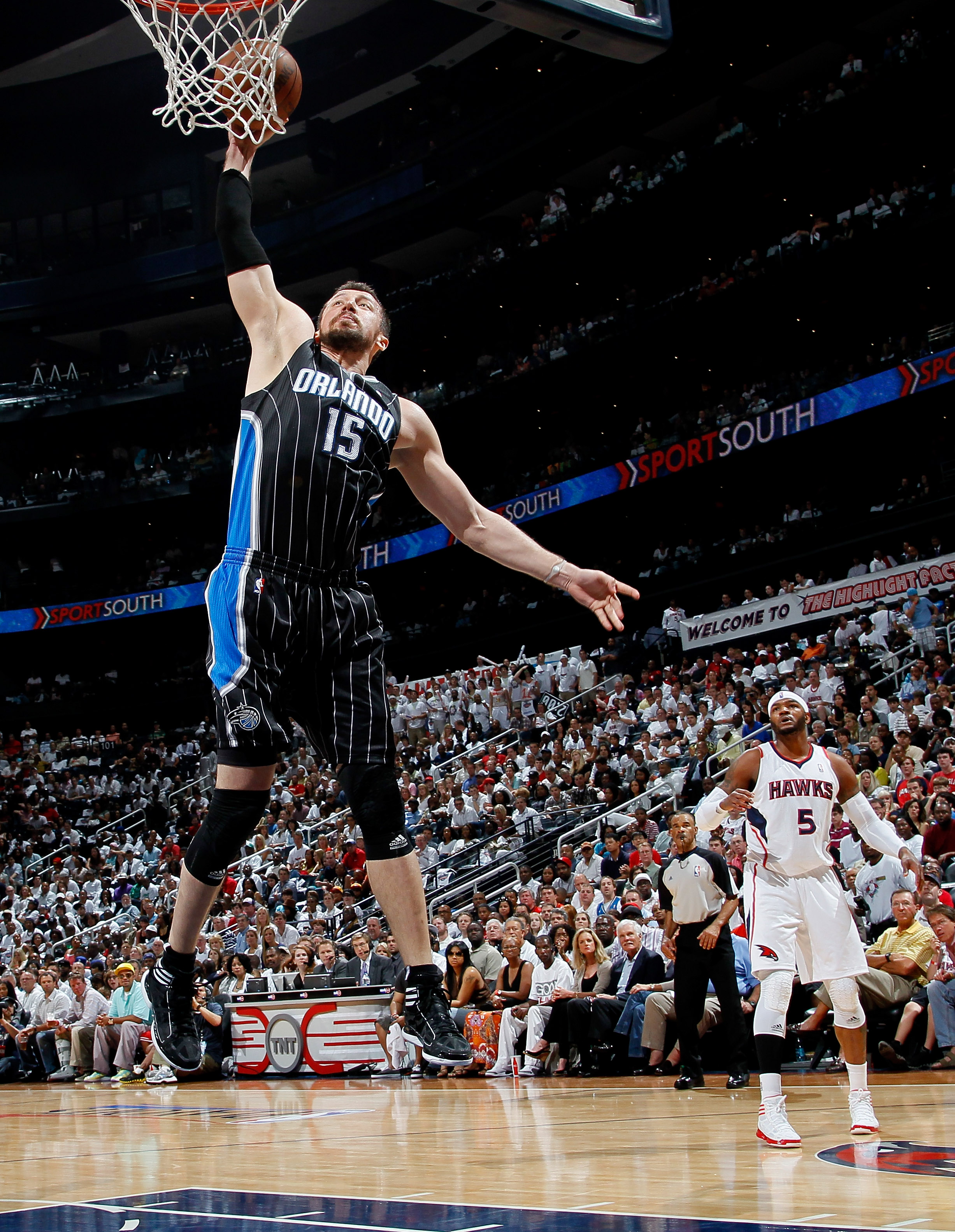 ATLANTA, GA - APRIL 24: Hedo Turkoglu #15 of the Orlando Magic dunks past Josh Smith #5 of the Atlanta Hawks during Game Four of the Eastern Conference Quarterfinals in the 2011 NBA Playoffs at Philips Arena on April 24, 2011 in Atlanta, Georgia. NOTE T