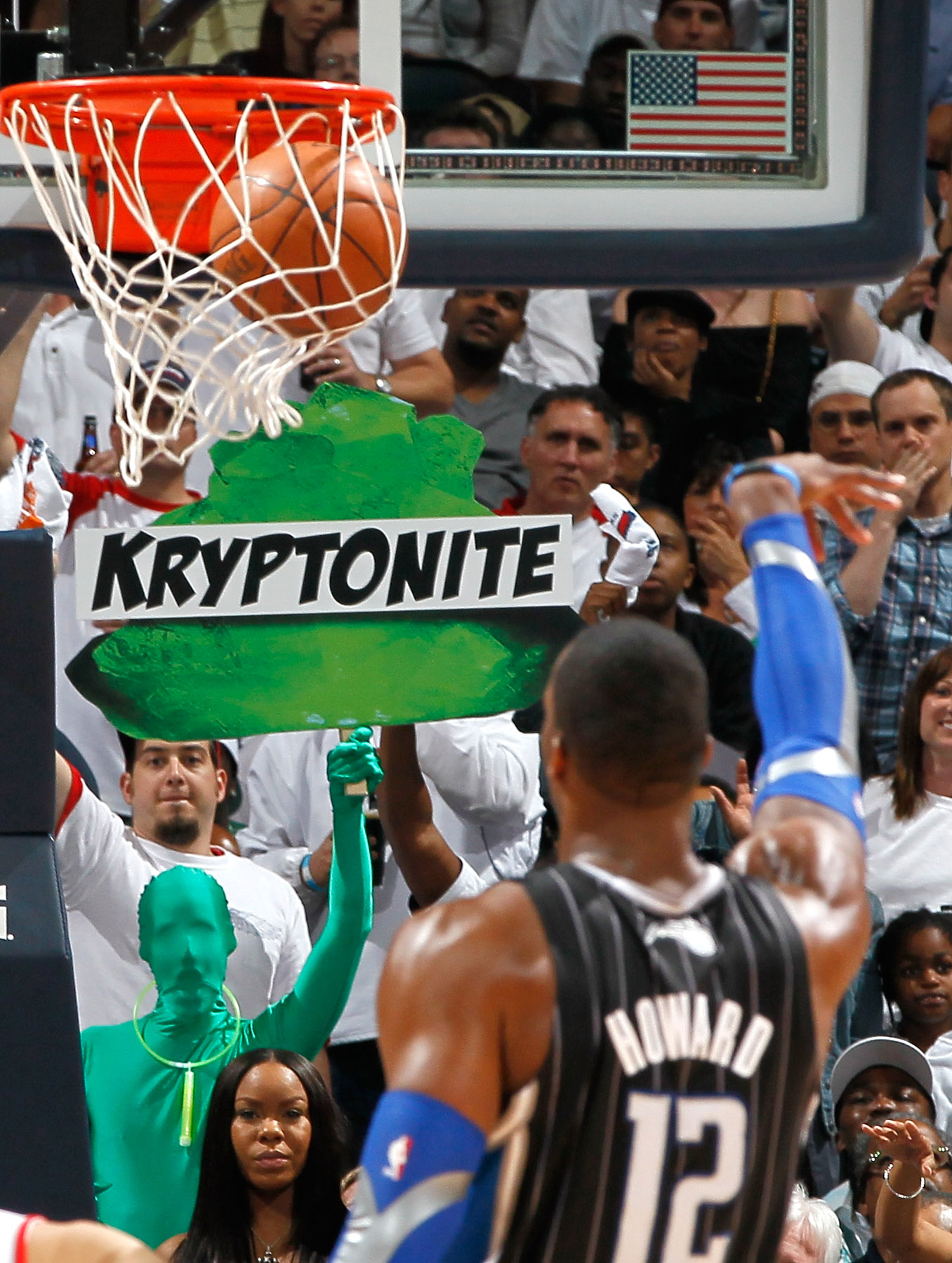 ATLANTA, GA - APRIL 28: Dwight Howard #12 of the Orlando Magic makes a free throw while a fan holds up a neon green sign with the words 'Kryptonite' on it during Game Six of the Eastern Conference Quarterfinals in the 2011 NBA Playoffs against the Atlant