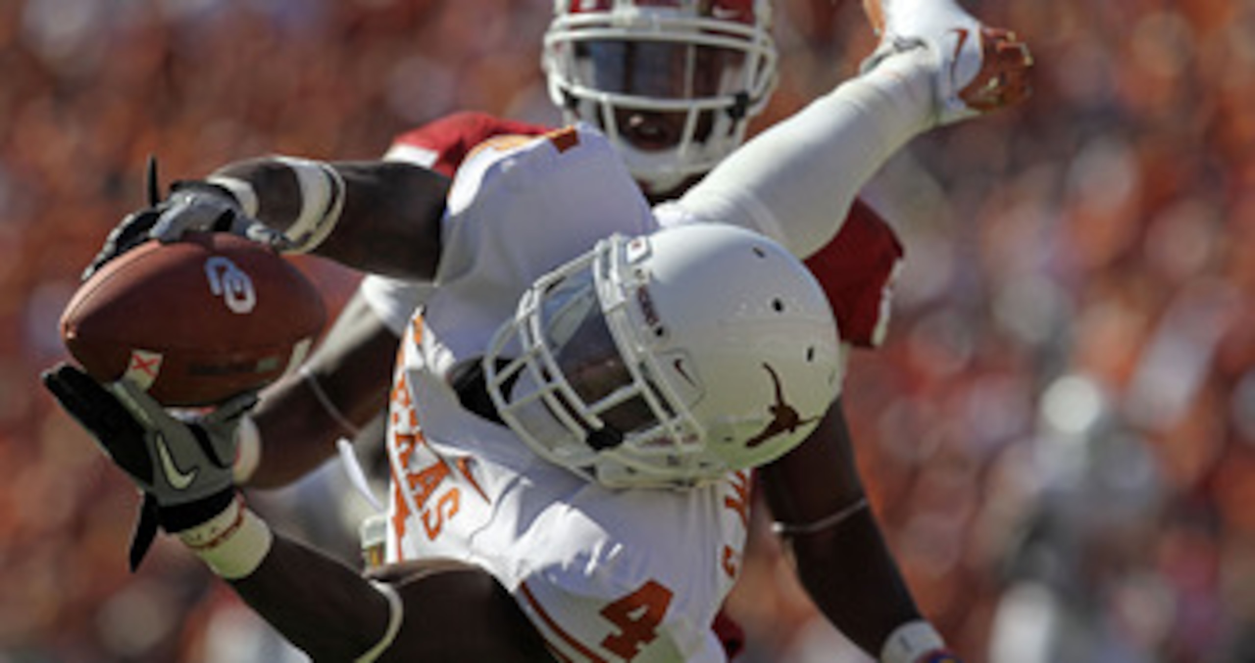DALLAS - OCTOBER 02:  Cornerback Aaron Williams #4 of the Texas Longhorns drops a pass intended for Ryan Broyles #85 of the Oklahoma Sooners in the second quarter at the Cotton Bowl on October 2, 2010 in Dallas, Texas.  (Photo by Ronald Martinez/Getty Ima