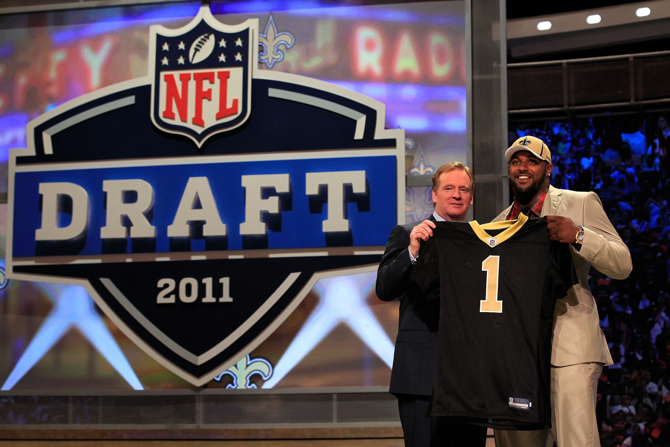 NEW YORK, NY - APRIL 28: NFL Commissioner Roger Goodell (L) poses for a photo with Cameron Jordan, #24 overall pick by the New Orleans Saints, holds up a jersey on stage during the 2011 NFL Draft at Radio City Music Hall on April 28, 2011 in New York Cit NEW YORK, NY - APRIL 28: NFL Commissioner Roger Goodell (L) poses for a photo with Cameron Jordan, #24 overall pick by the New Orleans Saints, holds up a jersey on stage during the 2011 NFL Draft at Radio City Music Hall on April 28, 2011 in New York Cit