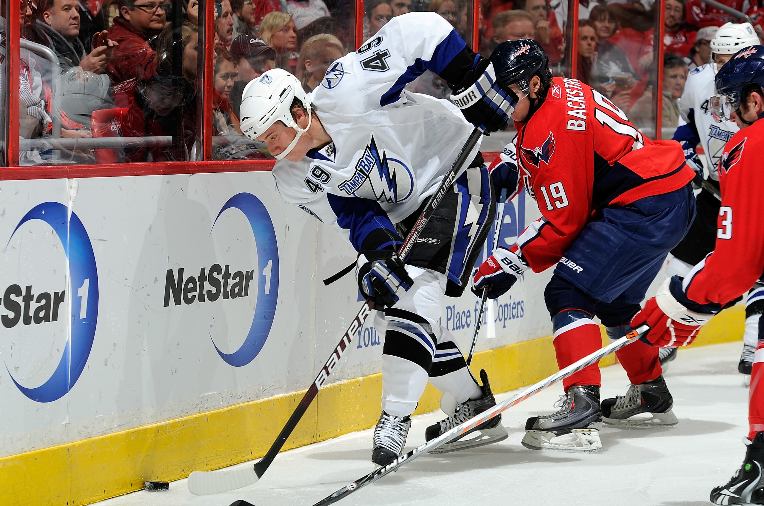 WASHINGTON - NOVEMBER 26:  Blair Jones #49 of the Tampa Bay Lightning battles for the puck with Nicklas Backstrom #19 of the Washington Capitals at the Verizon Center on November 26, 2010 in Washington, DC.  (Photo by Greg Fiume/Getty Images)