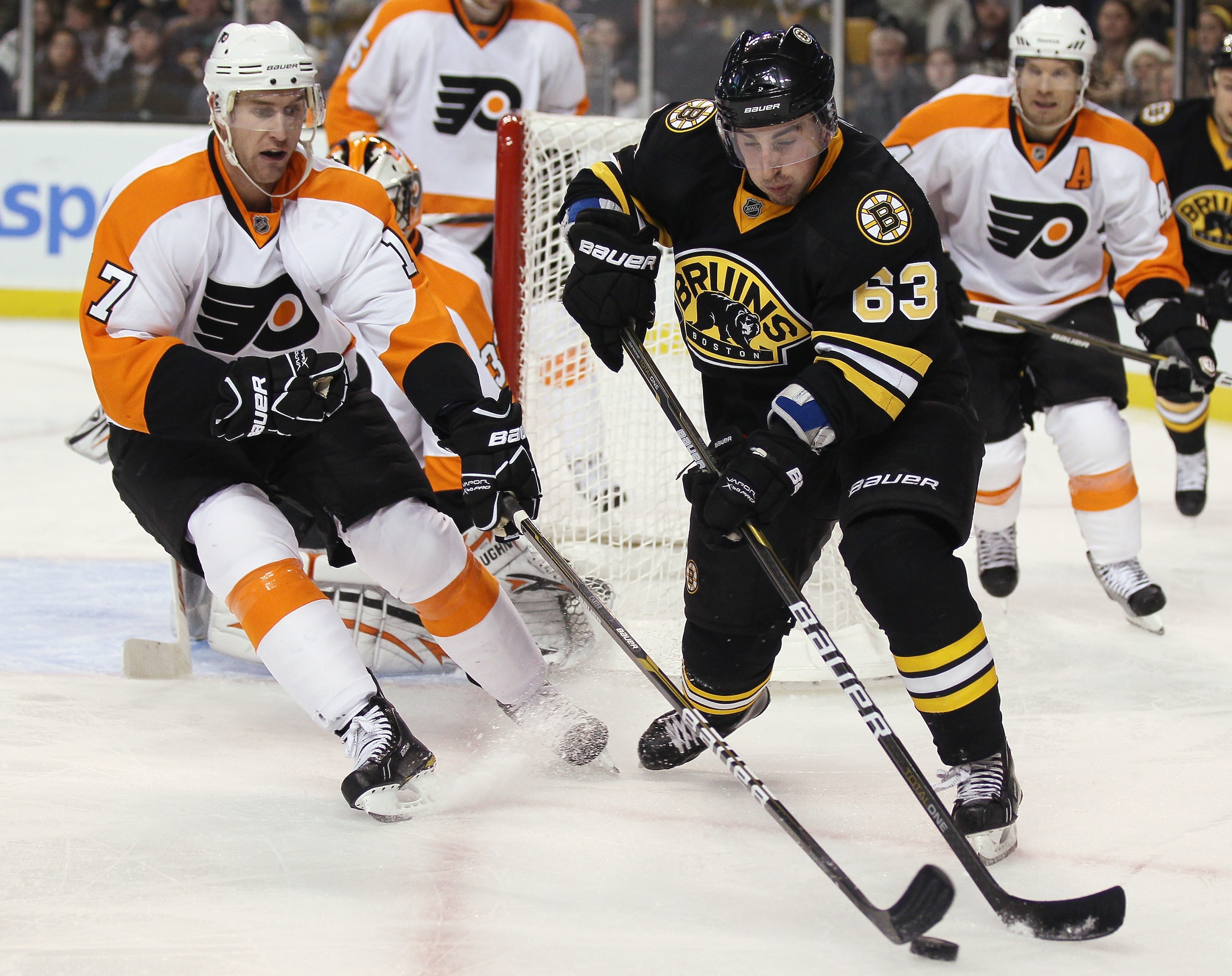 BOSTON, MA - DECEMBER 11:  Brad Marchand #63 of the Boston Bruins tries to keep the puck from Jeff Carter #17 of the Philadelphia Flyers on December 11, 2010 at the TD Garden in Boston, Massachusetts. The Flyers defeated the Bruins 2-1 in overtime.  (Phot