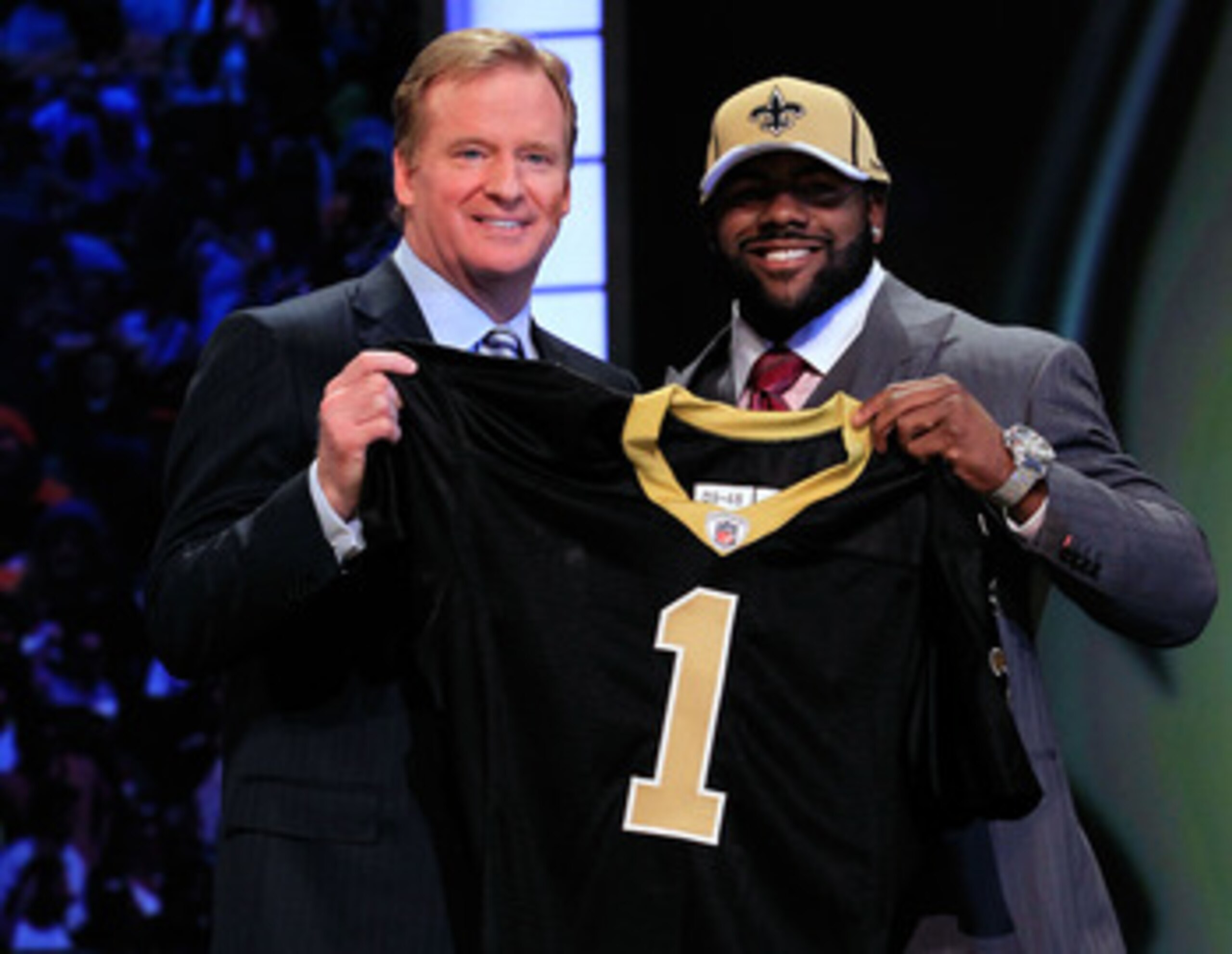 NEW YORK, NY - APRIL 28: NFL Commissioner Roger Goodell (L) poses for a photo with Mark Ingram, #28 overall pick by the New Orleans Saints, holds up a jersey on stage during the 2011 NFL Draft at Radio City Music Hall on April 28, 2011 in New York City. NEW YORK, NY - APRIL 28: NFL Commissioner Roger Goodell (L) poses for a photo with Mark Ingram, #28 overall pick by the New Orleans Saints, holds up a jersey on stage during the 2011 NFL Draft at Radio City Music Hall on April 28, 2011 in New York City.