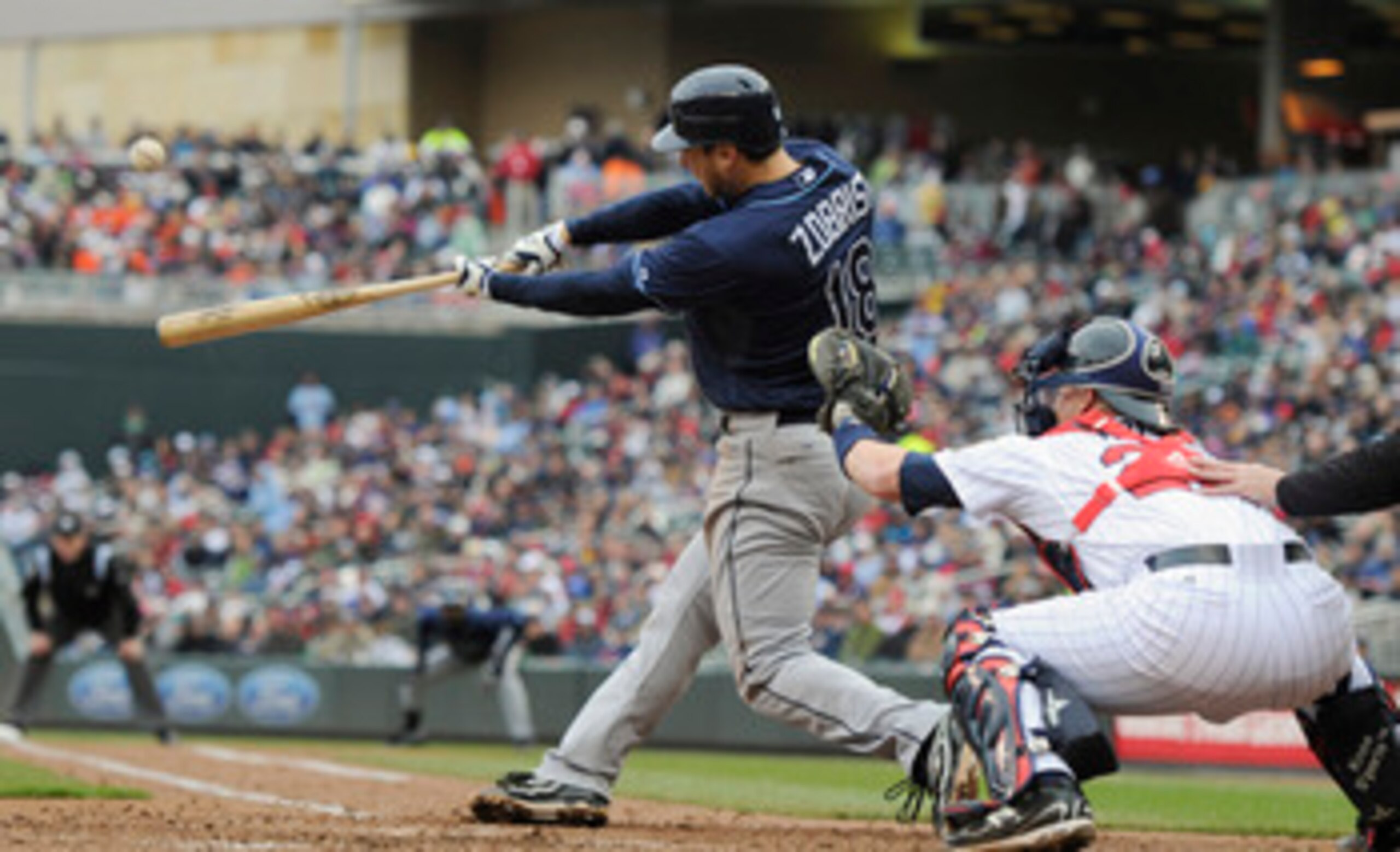 MINNEAPOLIS, MN - APRIL 28: Ben Zobrist #18 of the Tampa Bay Rays hits a three-run home run while Steve Holm #27 of the Minnesota Twins defends home plate during in the sixth inning of their game on April 28, 2011 at Target Field in Minneapolis, Minnesota