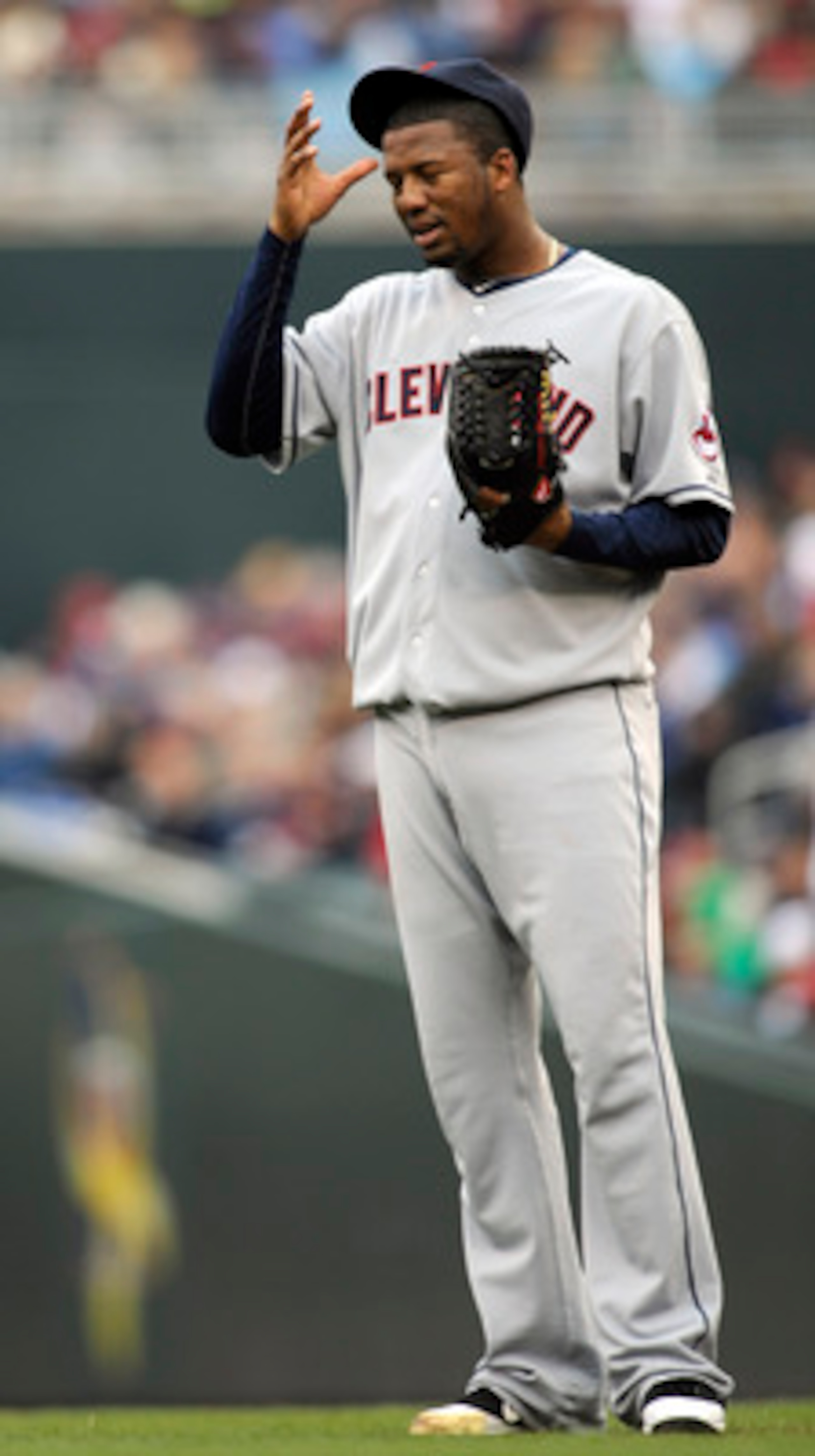 MINNEAPOLIS, MN - APRIL 23: Fausto Carmona #55 of the Cleveland Indians reacts to a wild pitch advancing a runner from second base to third base against the Minnesota Twins during the third inning of their game on April 23, 2011 at Target Field in Minneap