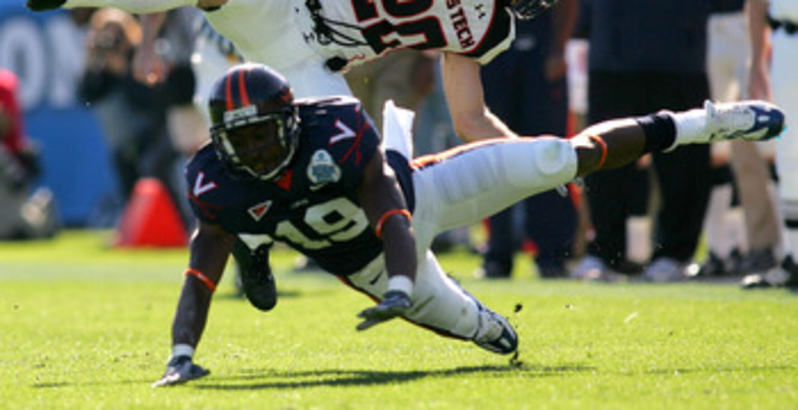 JACKSONVILLE, FL - JANUARY 01:  Danny Amendola #20 of the Texas Tech Red Raiders is tackled by  Ras-I Dowling #19 of the Virginia Cavaliers during the Gator Bowl at Jacksonville Municipal Stadium on January 1, 2008 in Jacksonville, Florida.  (Photo by Sam