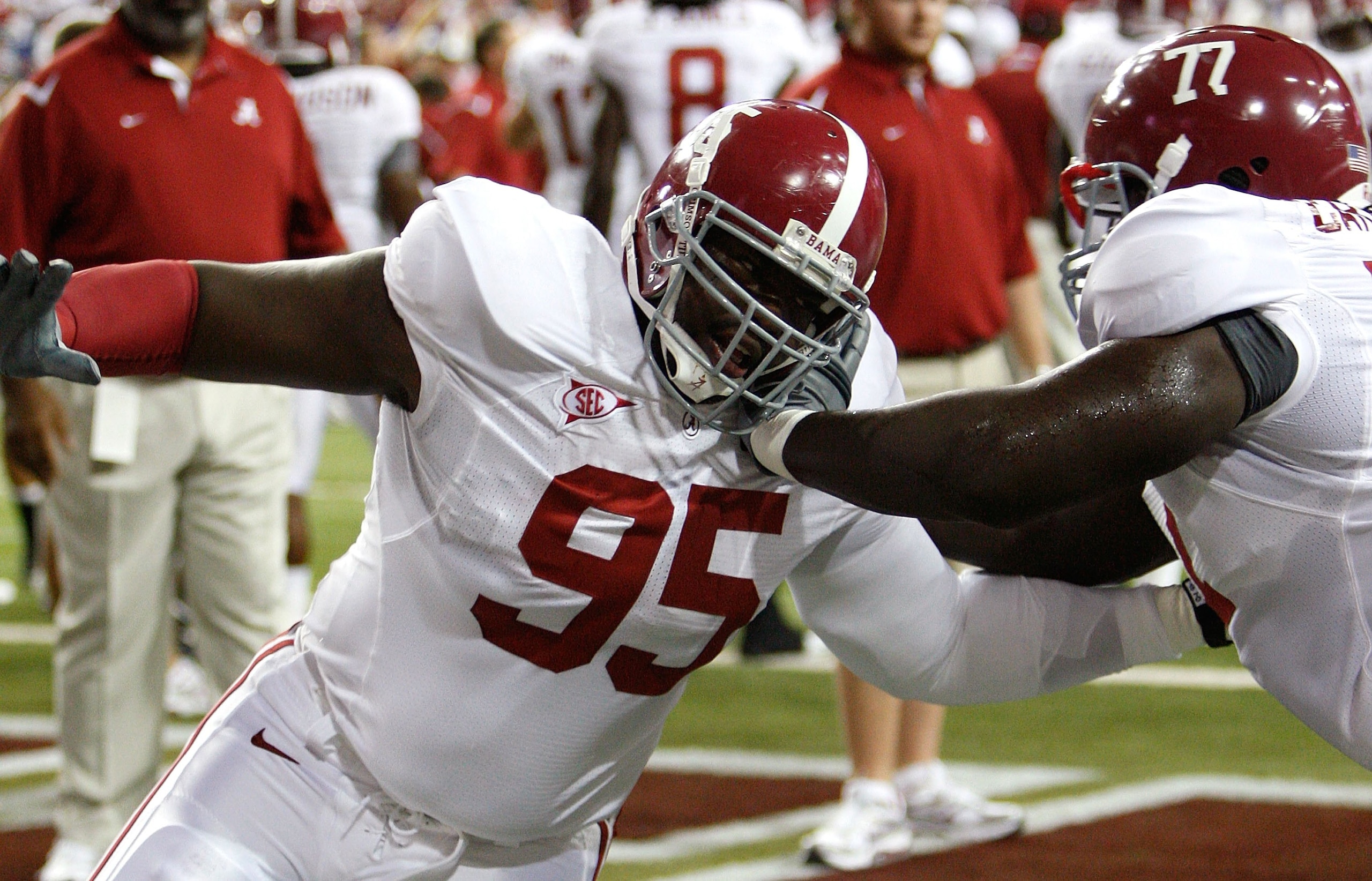 ATLANTA - SEPTEMBER 05:  Defensive lineman Brandon Deaderick #95 of the Alabama Crimson Tide warms up with James Carpenter #77 before facing the Virginia Tech Hokies during the Chick-fil-A Kickoff Game at Georgia Dome on September 5, 2009 in Atlanta, Geor