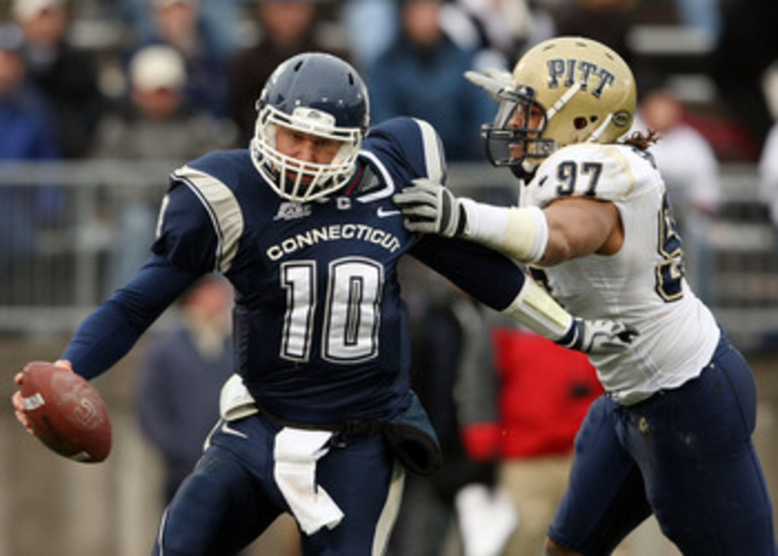 EAST HARTFORD, CT - DECEMBER 06: Zach Frazer #10 of the Connecticut Huskies narrowly escapes Jabaal Sheard #97 of the Pittsburgh Panthers on December 6, 2008 at Rentschler Field in East Hartford, Connecticut. The Panthers defeated the Huskies 34-10. (Ph EAST HARTFORD, CT - DECEMBER 06: Zach Frazer #10 of the Connecticut Huskies narrowly escapes Jabaal Sheard #97 of the Pittsburgh Panthers on December 6, 2008 at Rentschler Field in East Hartford, Connecticut. The Panthers defeated the Huskies 34-10. (Ph