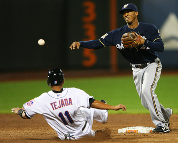 NEW YORK - SEPTEMBER 28:  Alcides Escobar #21 of the Milwaukee Brewers completes a double play while Ruben Tejada #11 of the New York Mets is unsuccessful sliding into second base on September 28, 2010 at Citi Field in the Flushing neighborhood of the Que