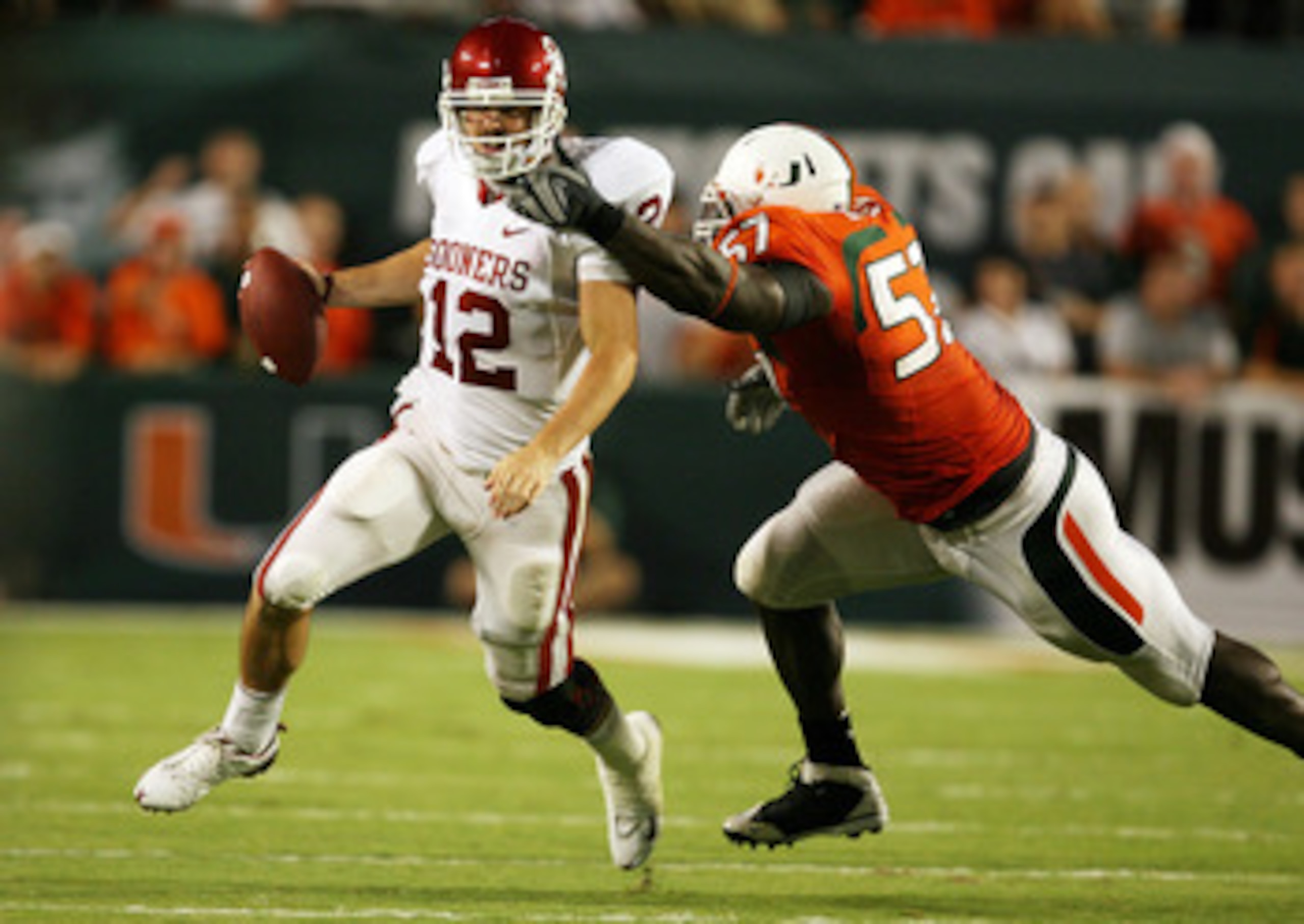 FORT LAUDERDALE, FL - OCTOBER 03: Quarterback Landry Jones #12 of the Oklahoma Sooners is sacked by defensive lineman Allen Bailey #57 of the Miami Hurricanes knocked down a pass attempt at Land Shark Stadium on October 3, 2009 in Fort Lauderdale, Florida FORT LAUDERDALE, FL - OCTOBER 03: Quarterback Landry Jones #12 of the Oklahoma Sooners is sacked by defensive lineman Allen Bailey #57 of the Miami Hurricanes knocked down a pass attempt at Land Shark Stadium on October 3, 2009 in Fort Lauderdale, Florida