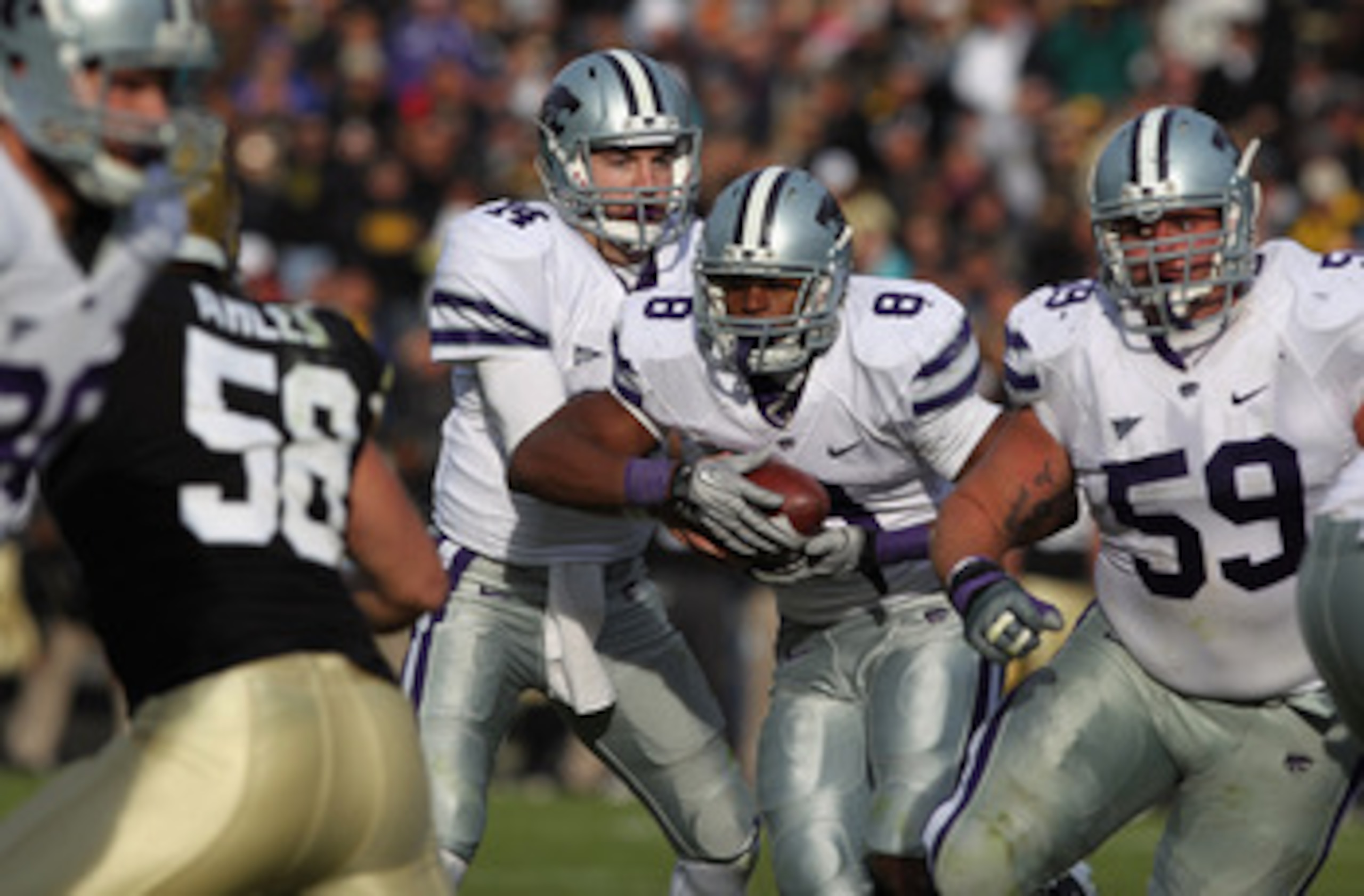 BOULDER, CO - NOVEMBER 20:  Quarterback Carson Coffman #14 of the Kansas State Wildcats fakes a handoff to running back Daniel Thomas #8 before rushing six yards for a touchdown against the Colorado Buffaloes at Folsom Field on November 20, 2010 in Boulde