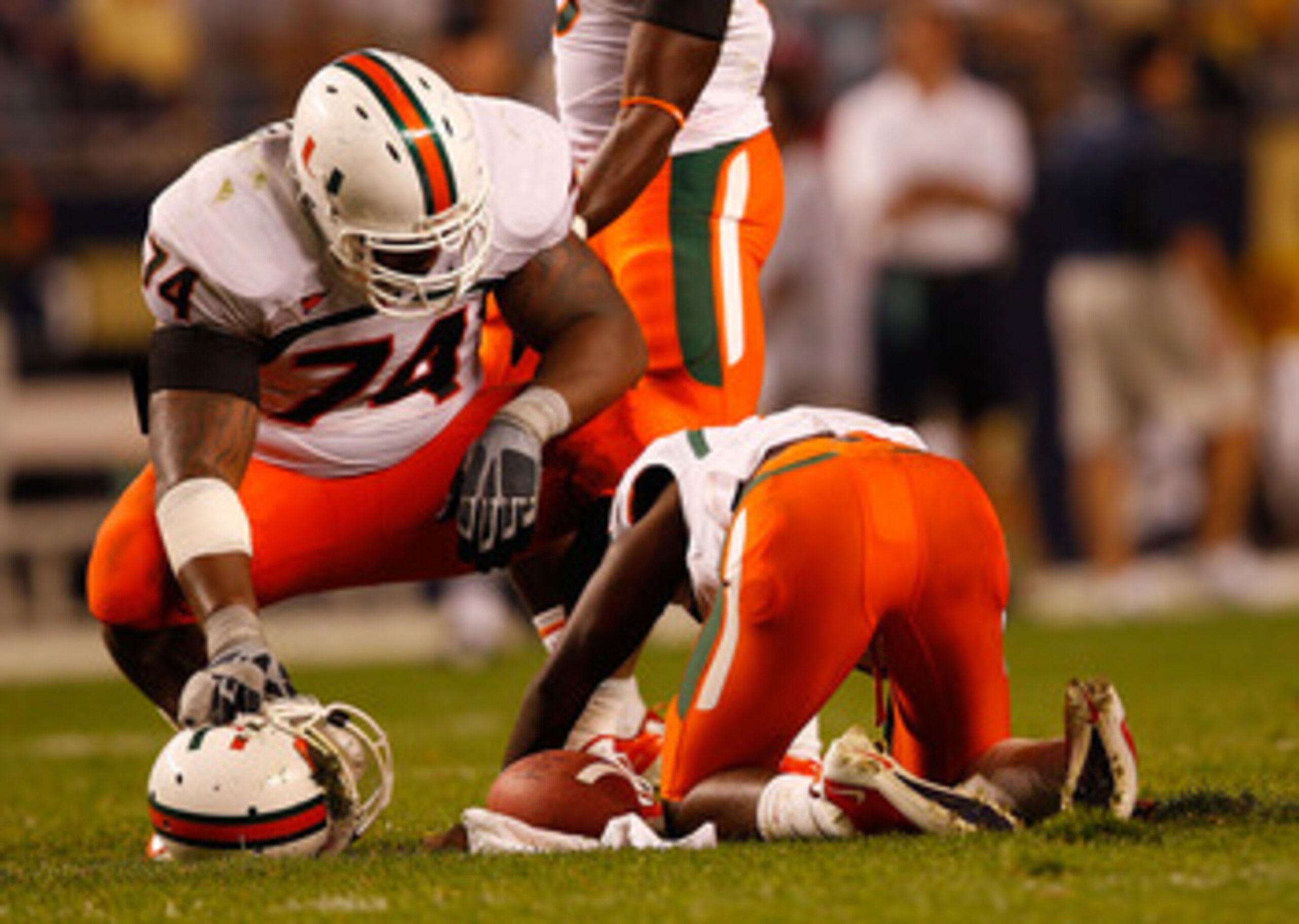 PITTSBURGH - SEPTEMBER 23: Jacory Harris #12 of the Miami Hurricanes lays on the ground as teammate Orlando Franklin #74 looks on after being sacked by the Pittsburgh Panthers on September 23, 2010 at Heinz Field in Pittsburgh, Pennsylvania. (Photo by J PITTSBURGH - SEPTEMBER 23: Jacory Harris #12 of the Miami Hurricanes lays on the ground as teammate Orlando Franklin #74 looks on after being sacked by the Pittsburgh Panthers on September 23, 2010 at Heinz Field in Pittsburgh, Pennsylvania. (Photo by J