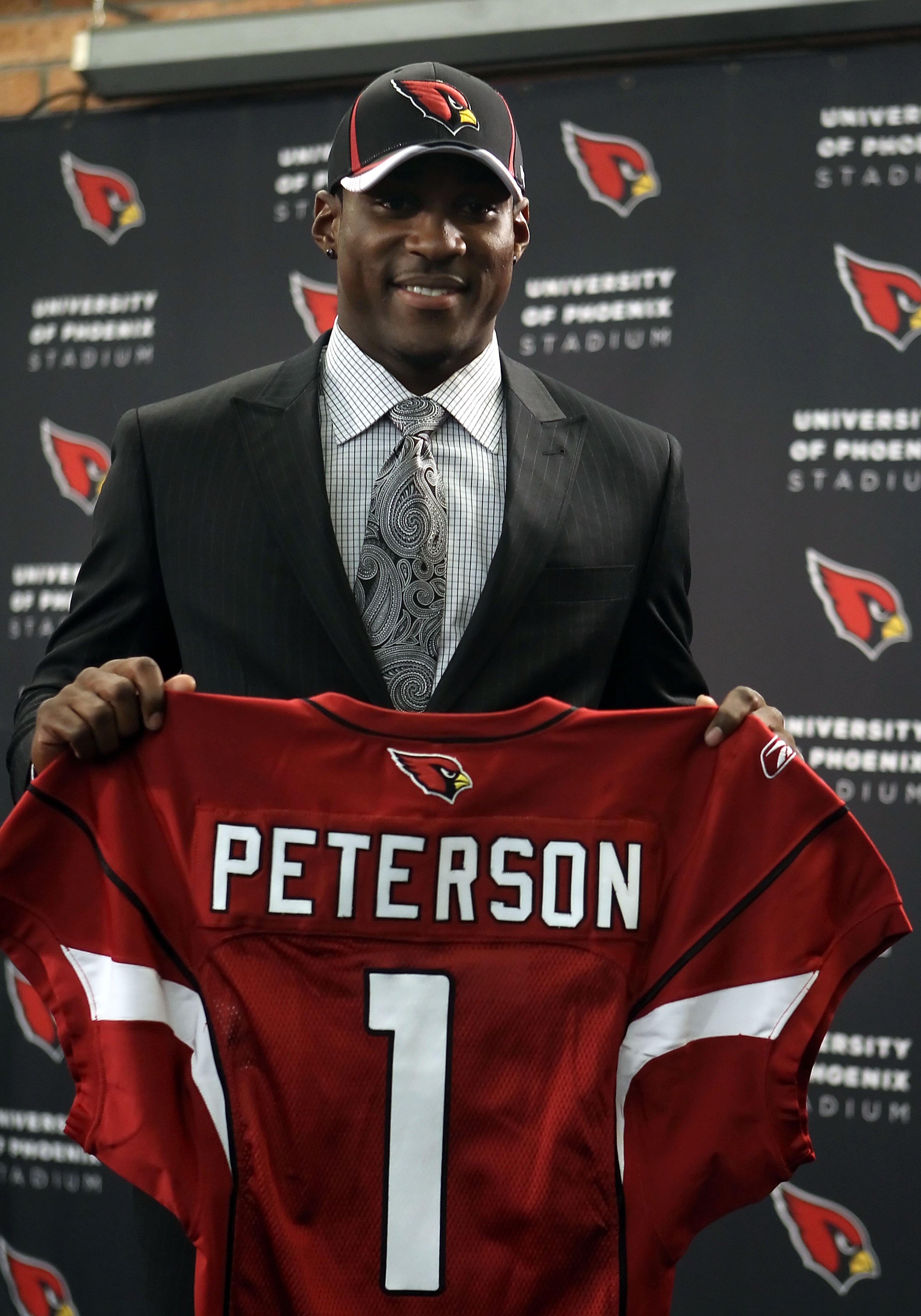 TEMPE, AZ - APRIL 29: First round draft pick Patrick Peterson of the Arizona Cardinals poses with a team jersey during a press conference to introduce him at the team's training center auditorium on April 29, 2011 in Tempe, Arizona. (Photo by Christian TEMPE, AZ - APRIL 29: First round draft pick Patrick Peterson of the Arizona Cardinals poses with a team jersey during a press conference to introduce him at the team's training center auditorium on April 29, 2011 in Tempe, Arizona. (Photo by Christian