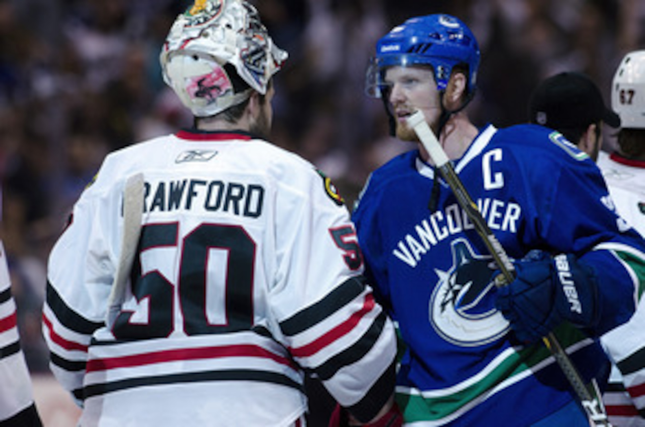 VANCOUVER, CANADA - APRIL 26: Henrik Sedin #33 (R) of the Vancouver Canucks and goalie Corey Crawford #50 of the Chicago Blackhawks shake hands after the Canucks defeated the Blackhawks 2-1 in overtime of Game Seven of the Western Conference Quarterfinals