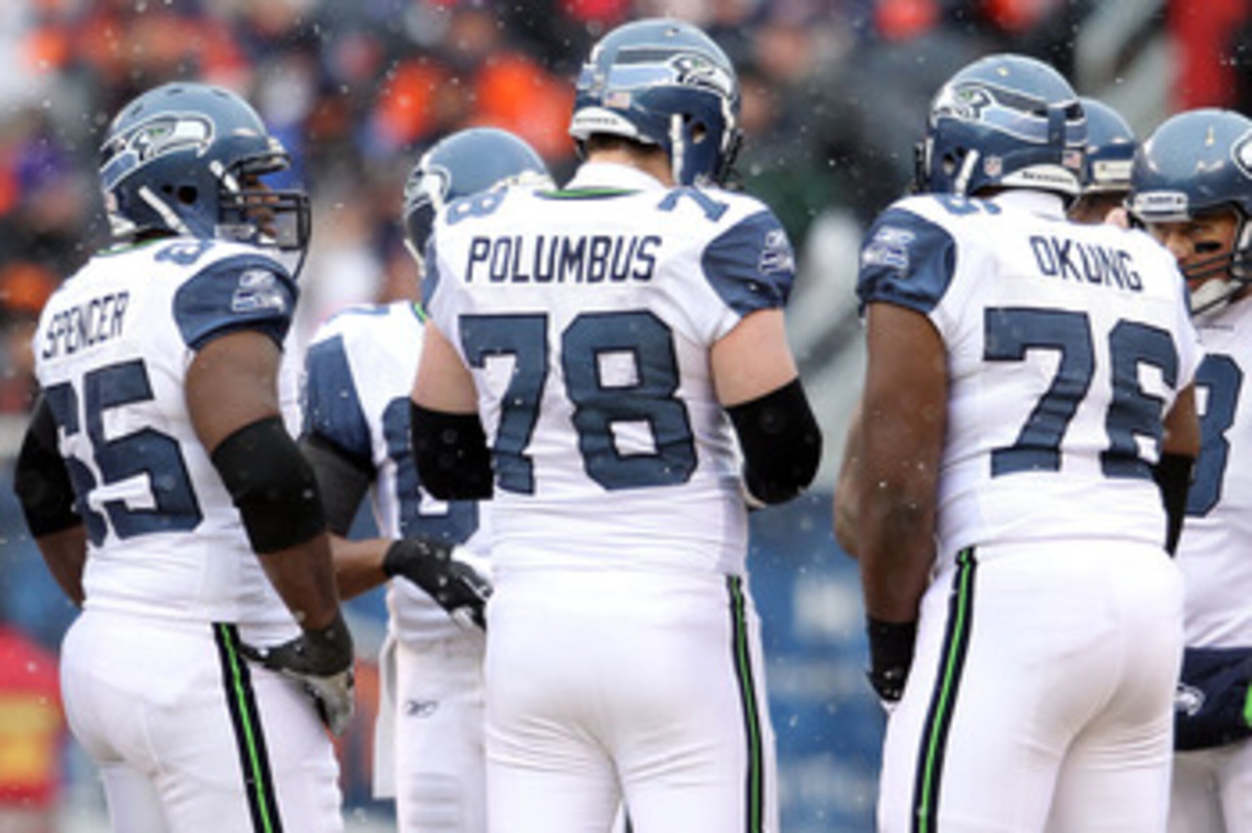 CHICAGO, IL - JANUARY 16:  (R) Quarterback Matt Hasselbeck #8 of the Seattle Seahawks huddles with Russell Okung #76, Tyler Polumbus #78 and other members of the Seahawks offensive line against the Chicago Bears in the 2011 NFC divisional playoff game at 
