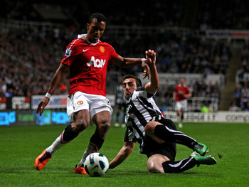 NEWCASTLE UPON TYNE, ENGLAND - APRIL 19:  Jose Enrique of Newcastle United challenges Nani of Manchester United during the Barclays Premier League match between Newcastle United and Manchester United at St James' Park on April 19, 2011 in Newcastle, Engla