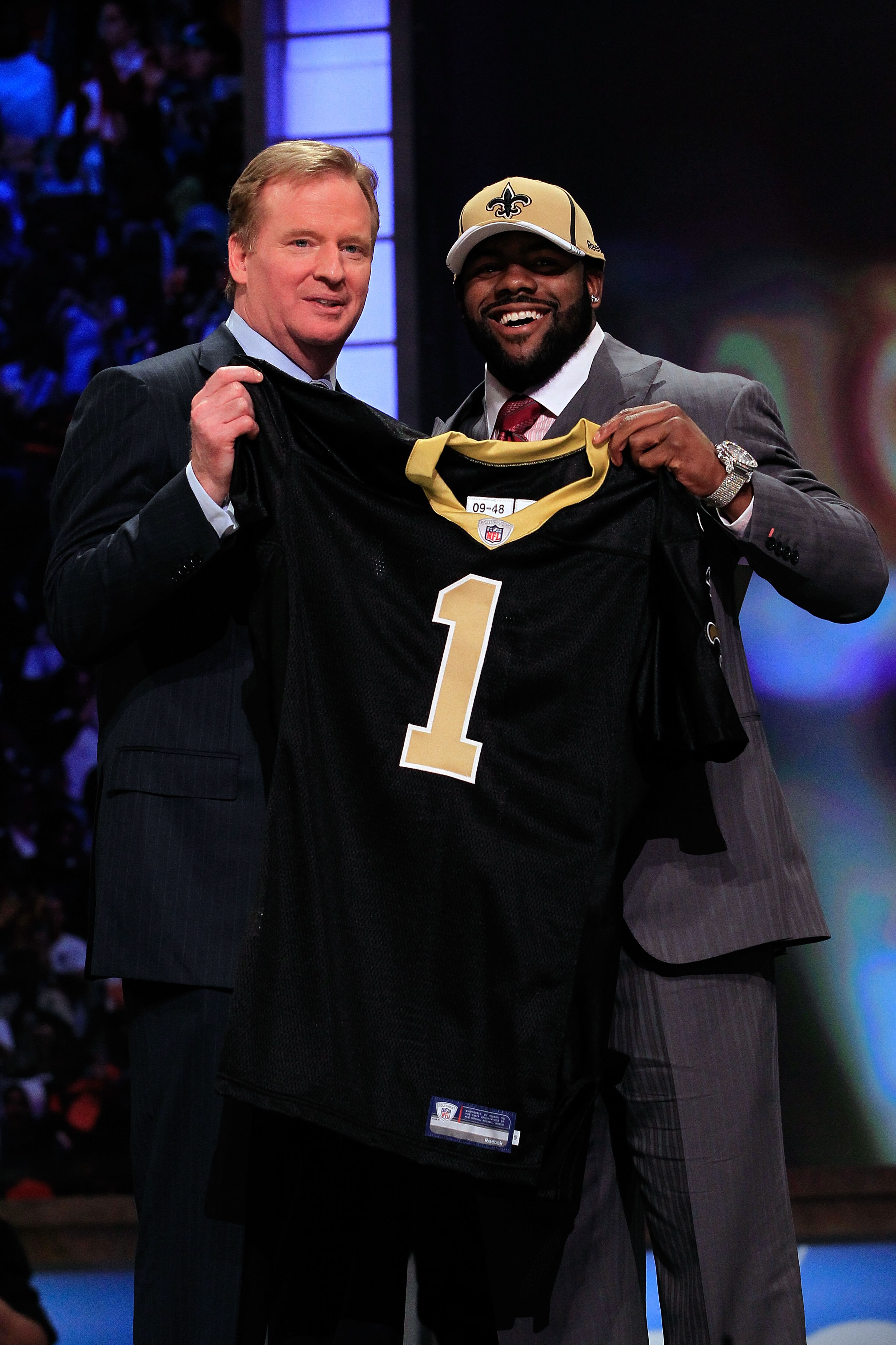 NEW YORK, NY - APRIL 28: NFL Commissioner Roger Goodell (L) poses for a photo with Mark Ingram, #28 overall pick by the New Orleans Saints, holds up a jersey on stage during the 2011 NFL Draft at Radio City Music Hall on April 28, 2011 in New York City. NEW YORK, NY - APRIL 28: NFL Commissioner Roger Goodell (L) poses for a photo with Mark Ingram, #28 overall pick by the New Orleans Saints, holds up a jersey on stage during the 2011 NFL Draft at Radio City Music Hall on April 28, 2011 in New York City.