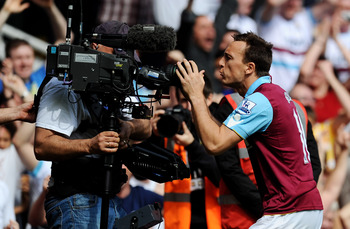 LONDON, ENGLAND - APRIL 02:  Mark Noble of West Ham United celebrates scoring his penalty with a TV cameraman during the Barclays Premier League match between West Ham United and Manchester United at the Boleyn Ground on April 2, 2011 in London, England.