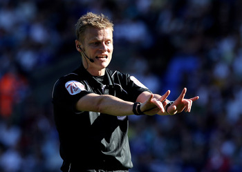 BOLTON, ENGLAND - APRIL 24:  Referee Mike Jones gestures during the Barclays Premier League match between Bolton Wanderers and Arsenal at the Reebok Stadium on April 24, 2011 in Bolton, England. (Photo by Michael Steele/Getty Images)