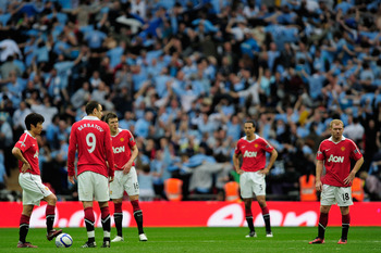 LONDON, ENGLAND - APRIL 16:  Man Utd players react after Yaya Toure of Manchester City scored the opening goal during the FA Cup sponsored by E.ON semi final match between Manchester City and Manchester United at Wembley Stadium on April 16, 2011 in Londo