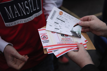 CRAWLEY, WEST SUSSEX - FEBRUARY 19:  Fans of the non-league football club Crawley Town hand out tickets before boarding coaches to Manchester to watch their team take on Manchester United in the FA Cup fifth round  on February 19, 2011 in Crawley, England
