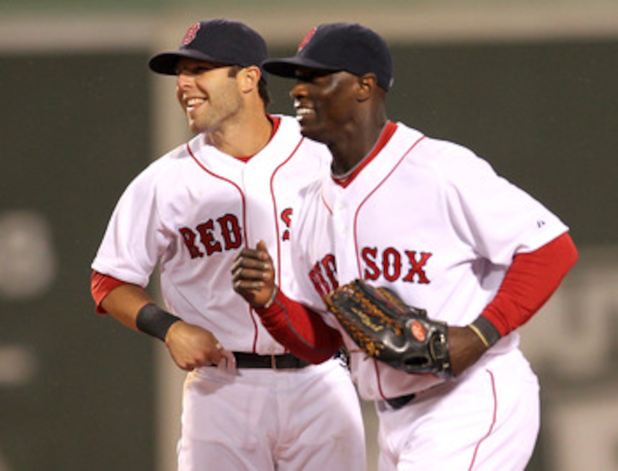 BOSTON, MA - APRIL 10:  Dustin Pedroia #15 and Mike Cameron #23 of the Boston Red Sox celebrate a win against the New York Yankees at Fenway Park April 10, 2011 in Boston, Massachusetts. (Photo by Jim Rogash/Getty Images)