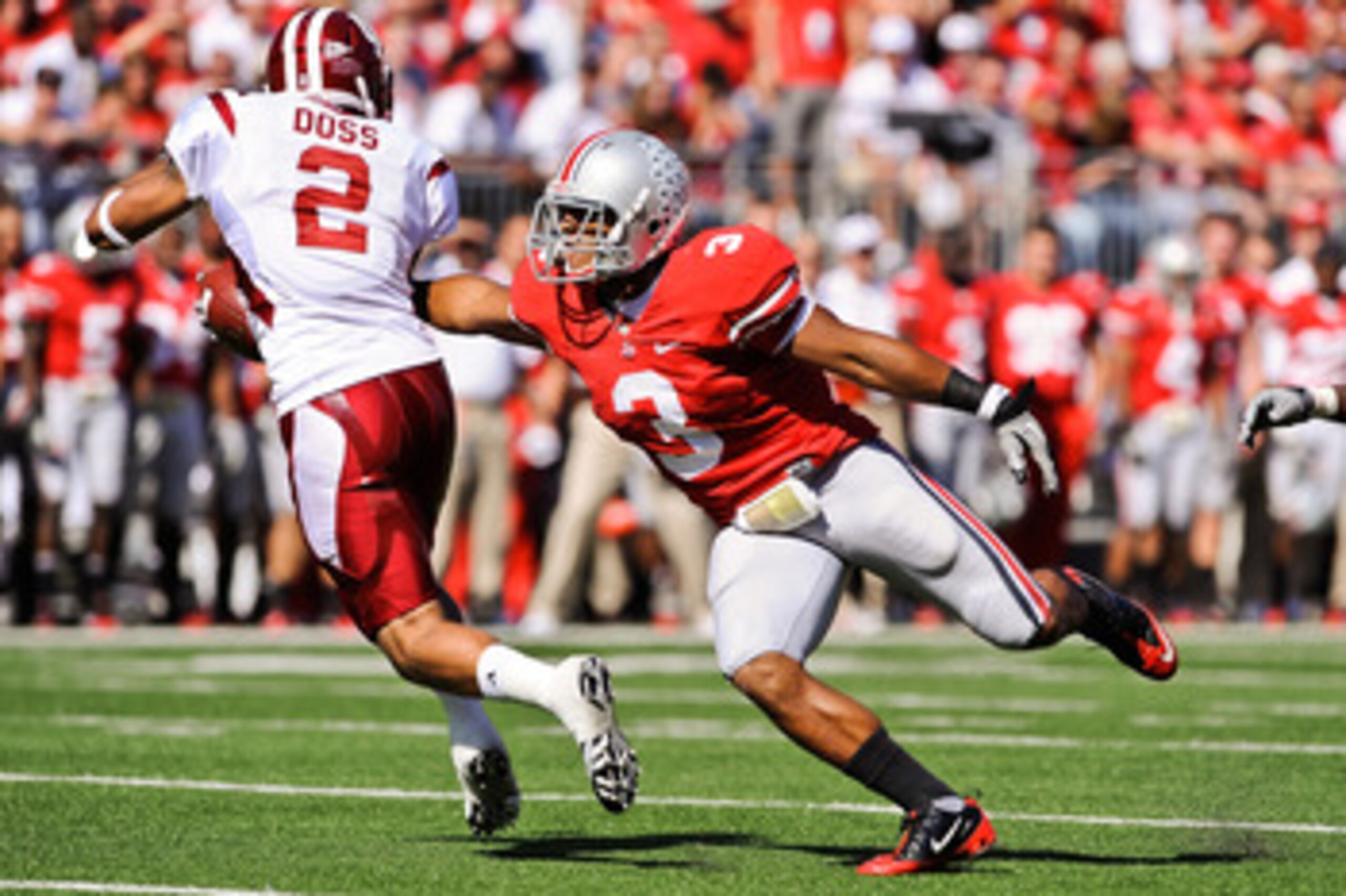 COLUMBUS, OH - OCTOBER 9:  Brandon Saine #3 of the Ohio State Buckeyes attempts to make a tackle on Tandon Doss #2 of the Indiana Hoosiers during a kickoff return at Ohio Stadium on October 9, 2010 in Columbus, Ohio.  (Photo by Jamie Sabau/Getty Images)