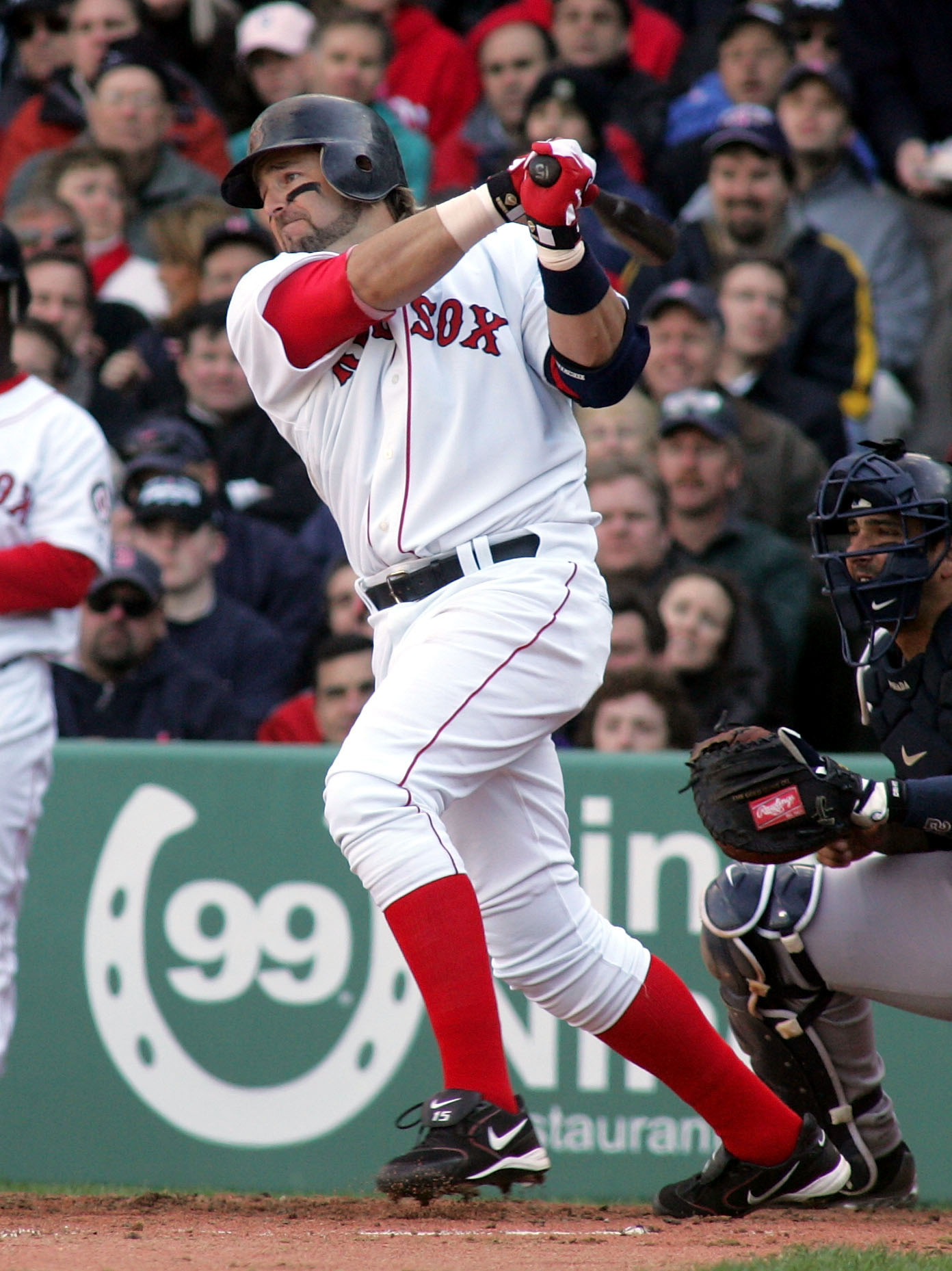 BOSTON - APRIL 11:  Kevin Millar #15 of the Boston Red Sox hits a two run base hit in the third inning against Mike Mussina of the New York Yankees scoring Trot Nixon and Manny Ramirez giving Boston a 4-0 lead during thier game at Fenway Park on April 11,