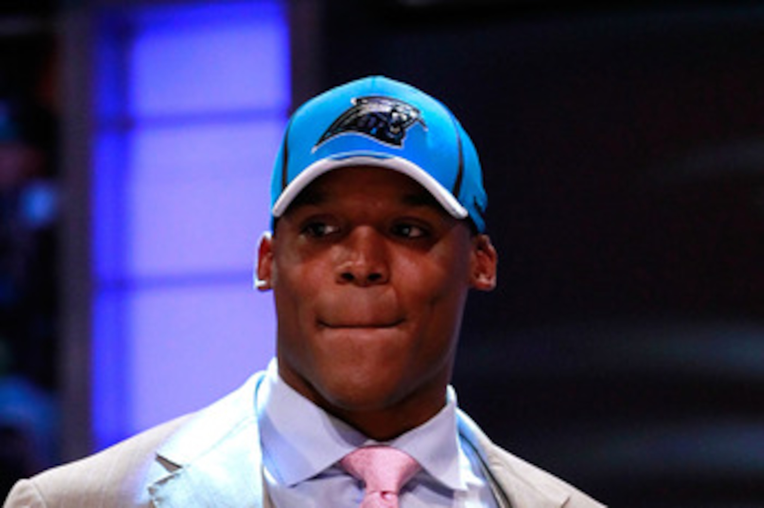 NEW YORK, NY - APRIL 28:  Cam Newton, #1 overall pick by the Carolina Panthers holds up a jersey on stage after he was picked during the 2011 NFL Draft at Radio City Music Hall on April 28, 2011 in New York City.  (Photo by Chris Trotman/Getty Images)