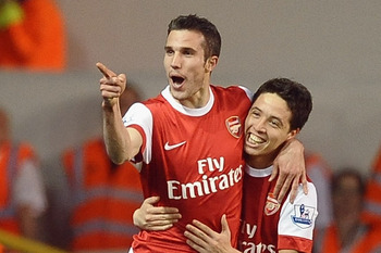LONDON, ENGLAND - APRIL 20:  Robin van Persie of Arsenal celebrates scoring their third goal with team mate Samir Nasri during the Barclays Premier League match between Tottenham Hotspur and Arsenal at White Hart Lane on April 20, 2011 in London, England.