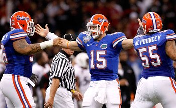 NEW ORLEANS - JANUARY 01:  Quarterback Tim Tebow #15 of the Florida Gators celebrates tossing a touchdown pass against the Cincinnati Bearcats with Maurice Pouncey #56 and Mike Pouncey #55 during the Allstate Sugar Bowl at the Louisana Superdome on Januar